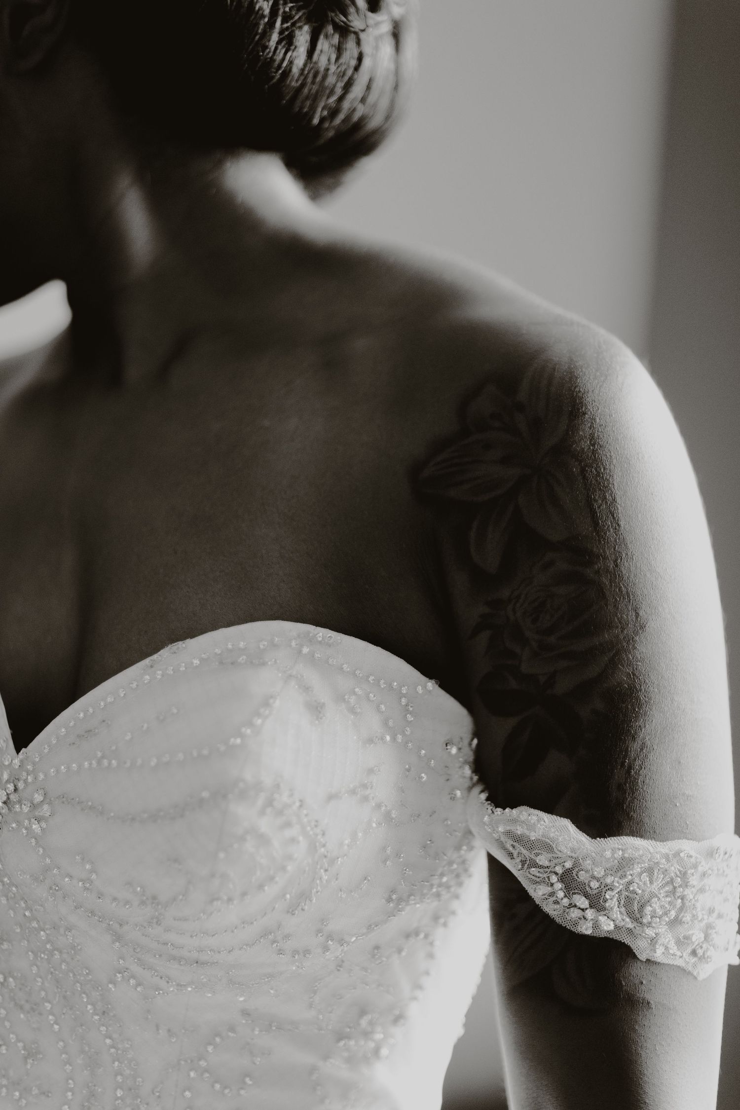 A close-up detail shot shows a lace wedding dress bodice and floral tattoo on the shoulder.
