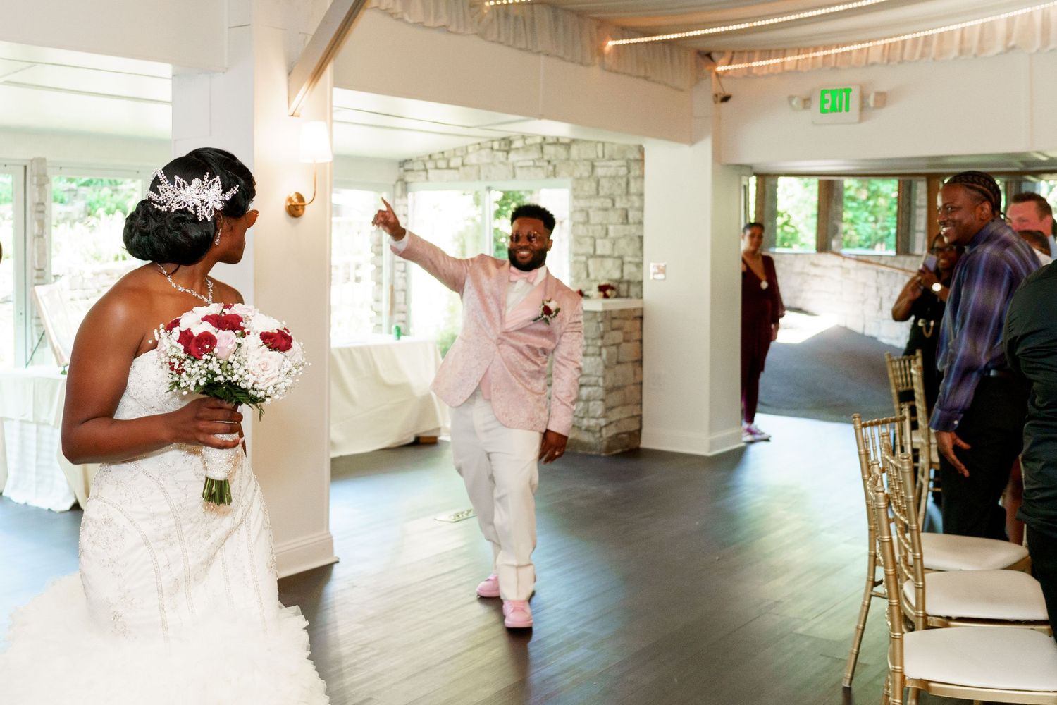A celebratory moment captured at a wedding reception with elegant white decor.