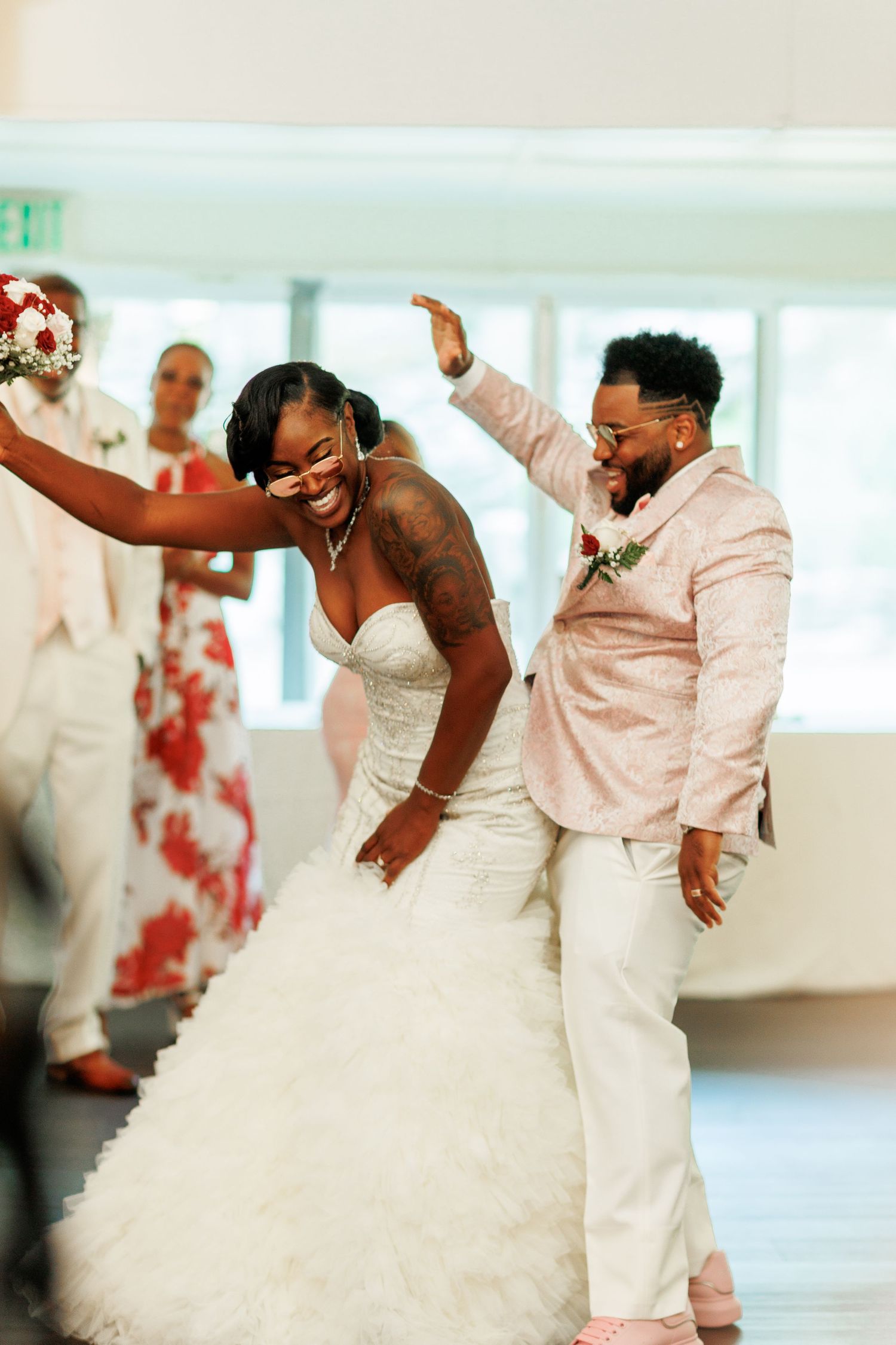 The newlyweds share an energetic dance moment at their reception.