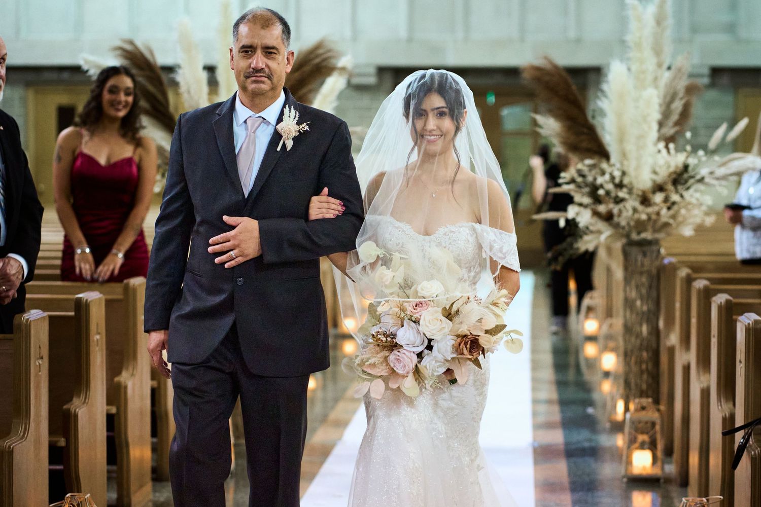 A bride and groom share intimate moments during their wedding ceremony at a traditional church venue.