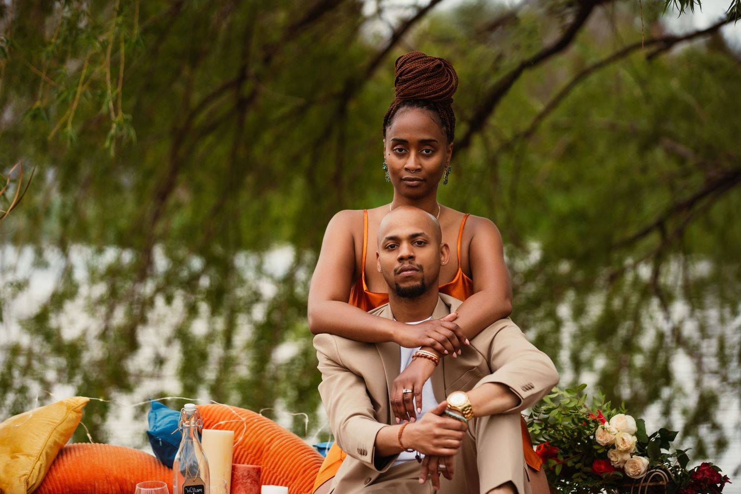 Intimate portrait of couple embracing during outdoor picnic photoshoot.