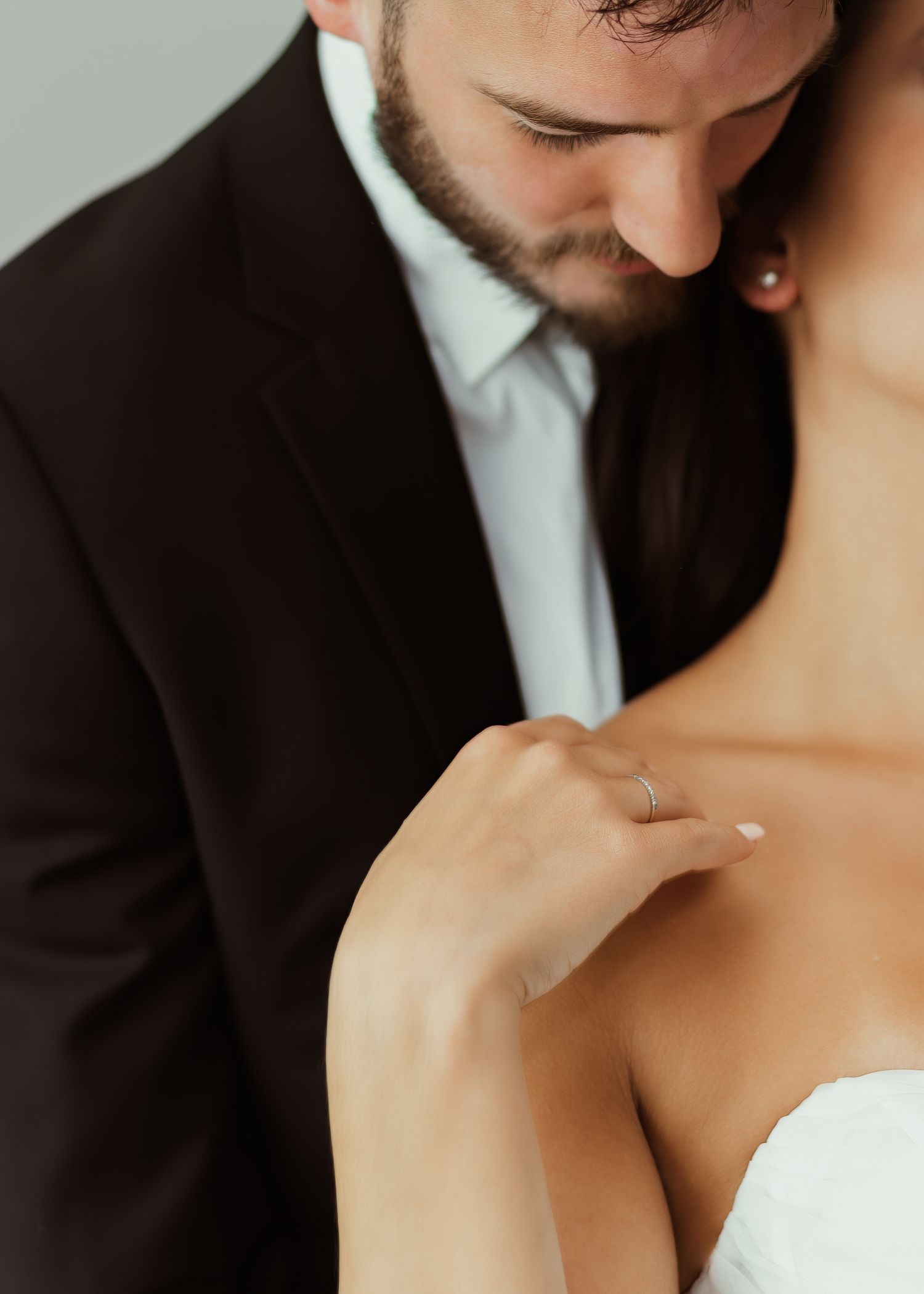 Intimate wedding portrait showing tender moment between newlyweds.