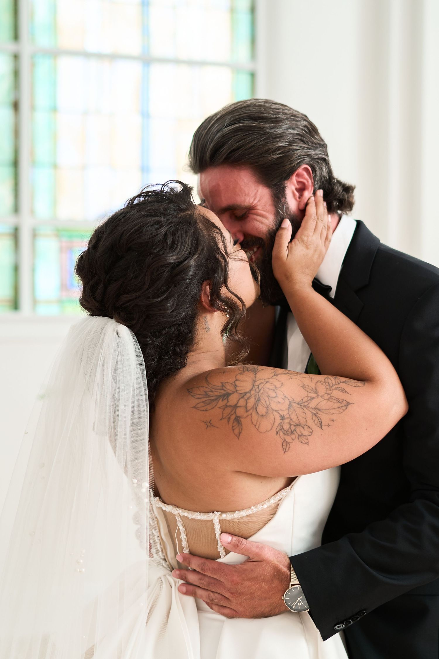 Romantic first look between newlyweds with bride in white dress and groom in black suit.