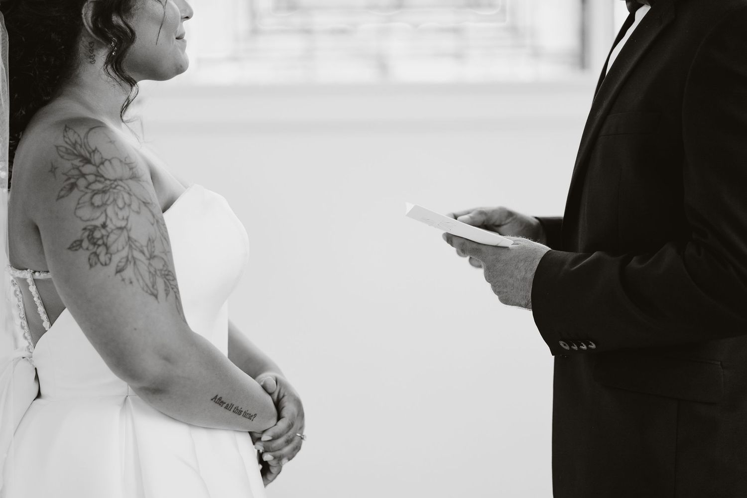 Black and white photo of a wedding ceremony with emotional exchange of vows.