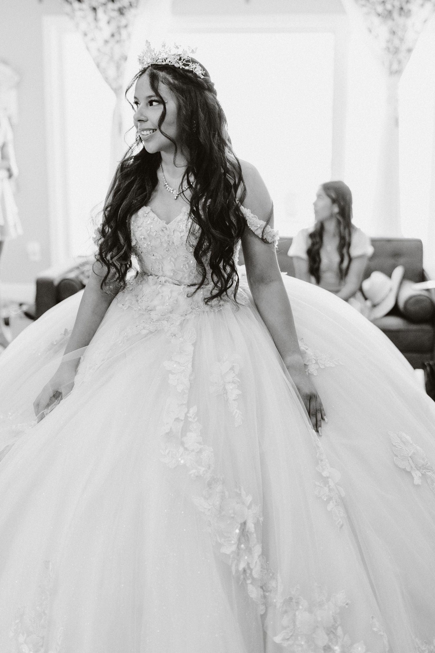 Black and white photos capture the movement of an elaborate quinceañera dress with intricate lace details.