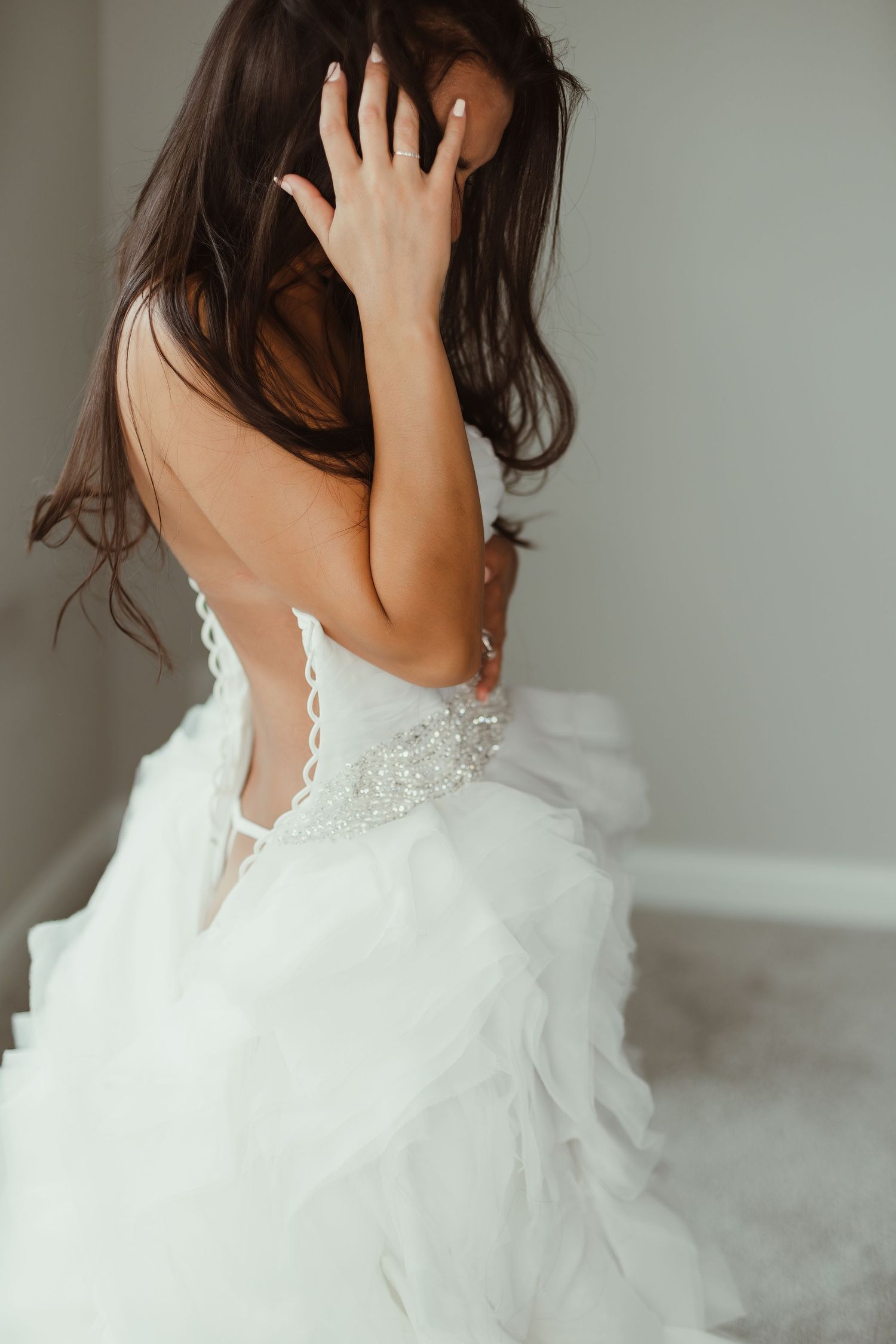 Elegant backless wedding dress with lace details and flowing tulle skirt.
