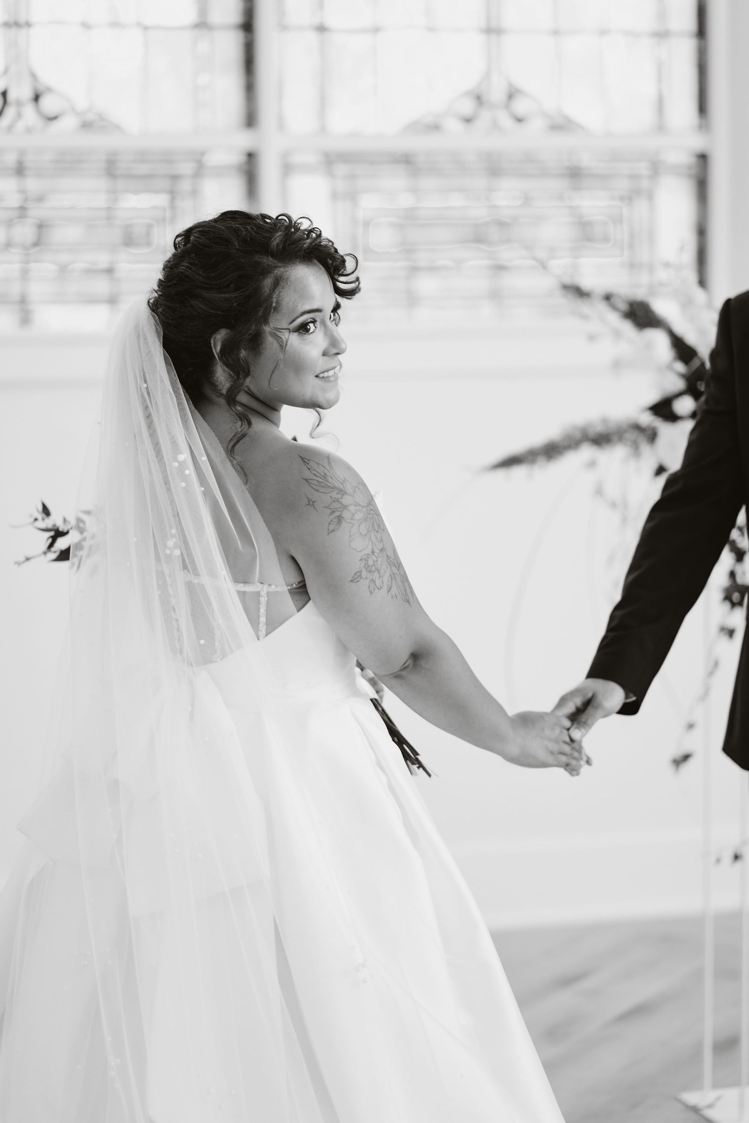 Black and white wedding portrait showing elegant bridal details.