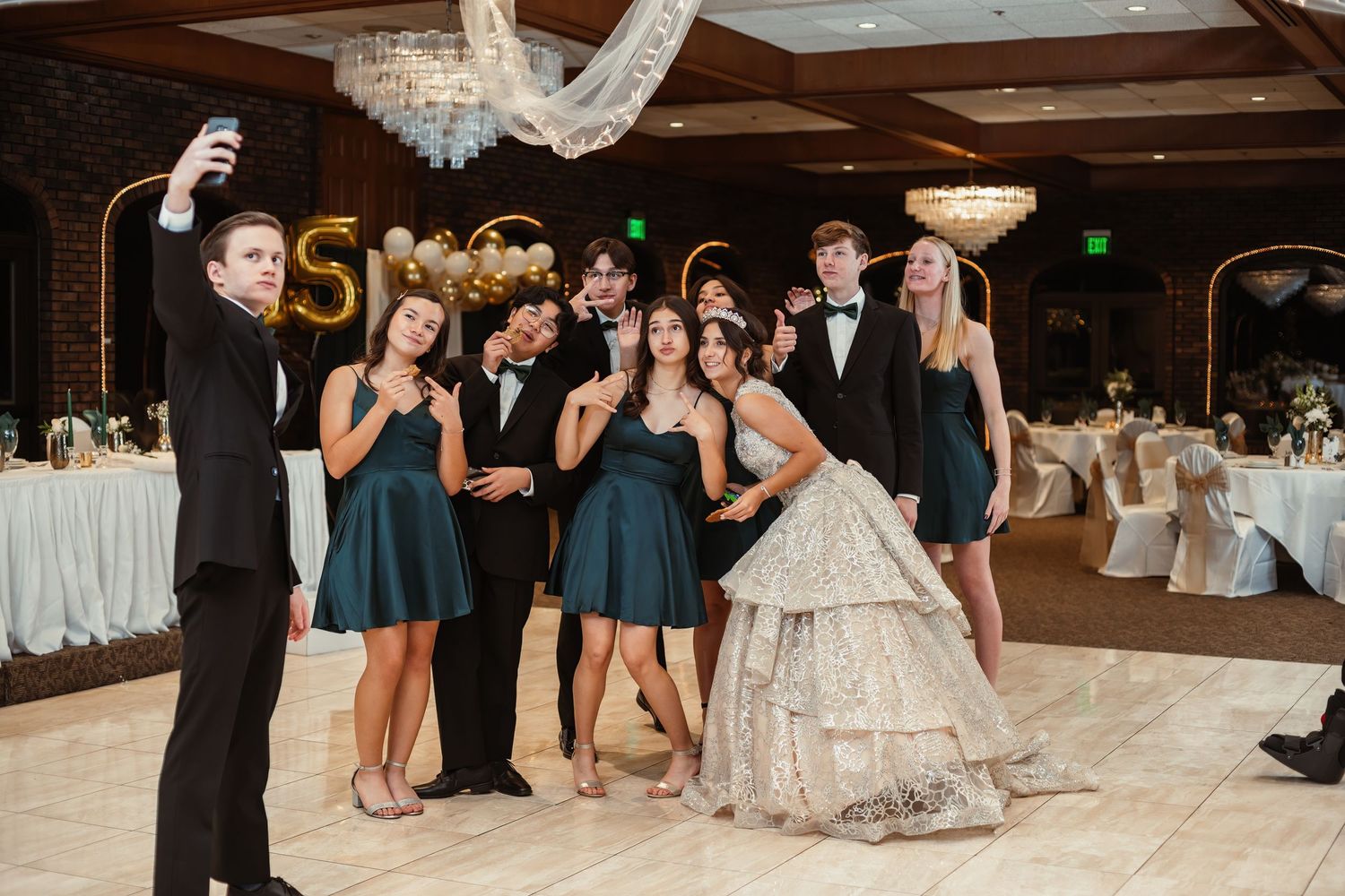 Wedding party taking selfies and having fun at reception.