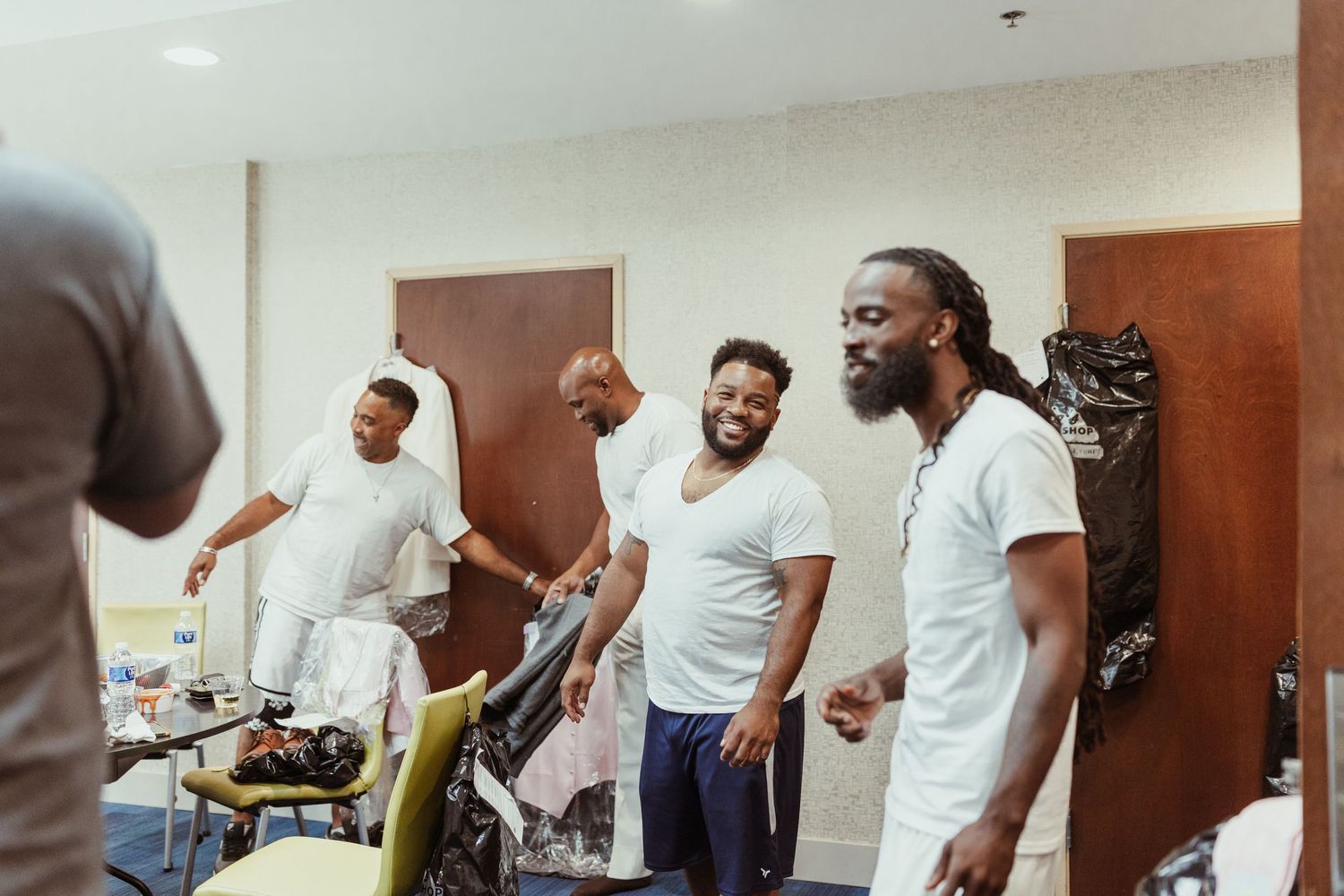 Group of friends sharing joyful moment and laughing together indoors.