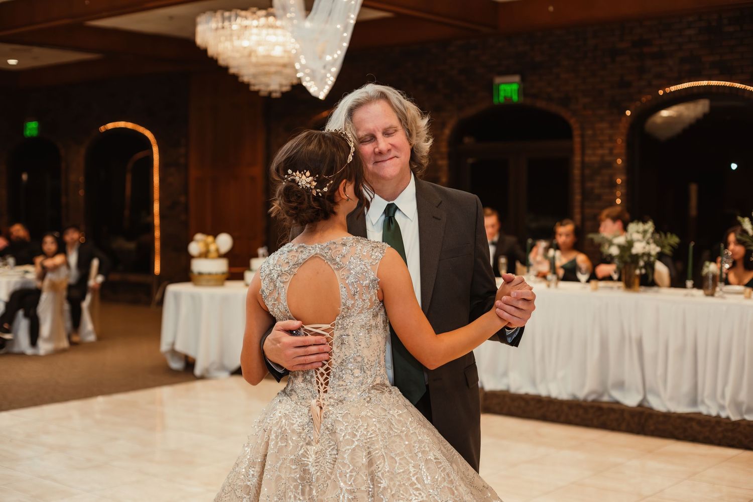 An emotional dance between partners during a wedding reception in an elegant ballroom setting.