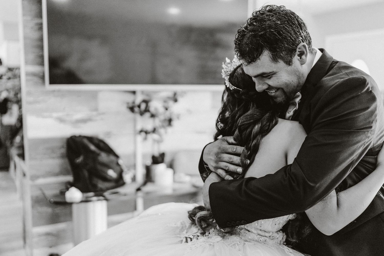 An emotional black and white moment captured during a wedding celebration.
