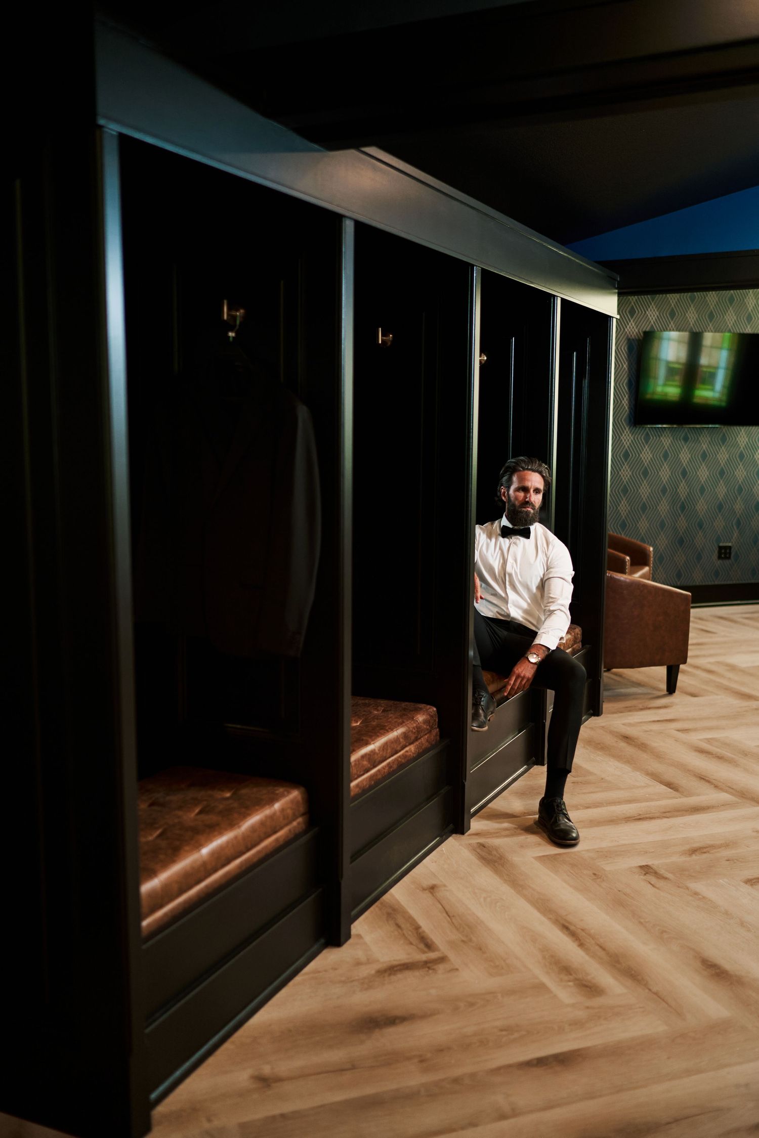 Dramatic black and white hallway photos featuring formal attire against dark wood paneling and herringbone floors.