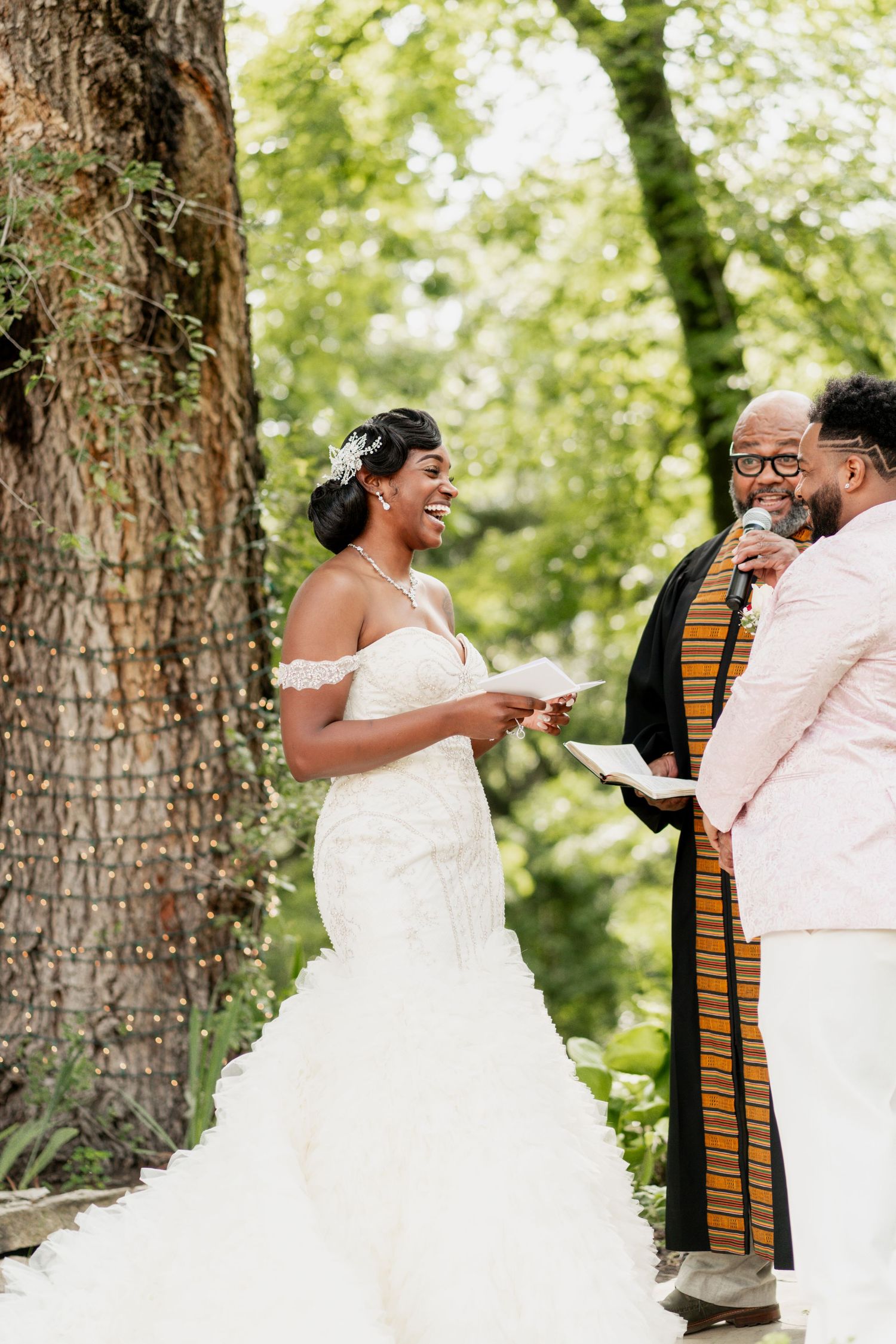A joyful moment during an outdoor wedding ceremony as participants exchange heartfelt words.