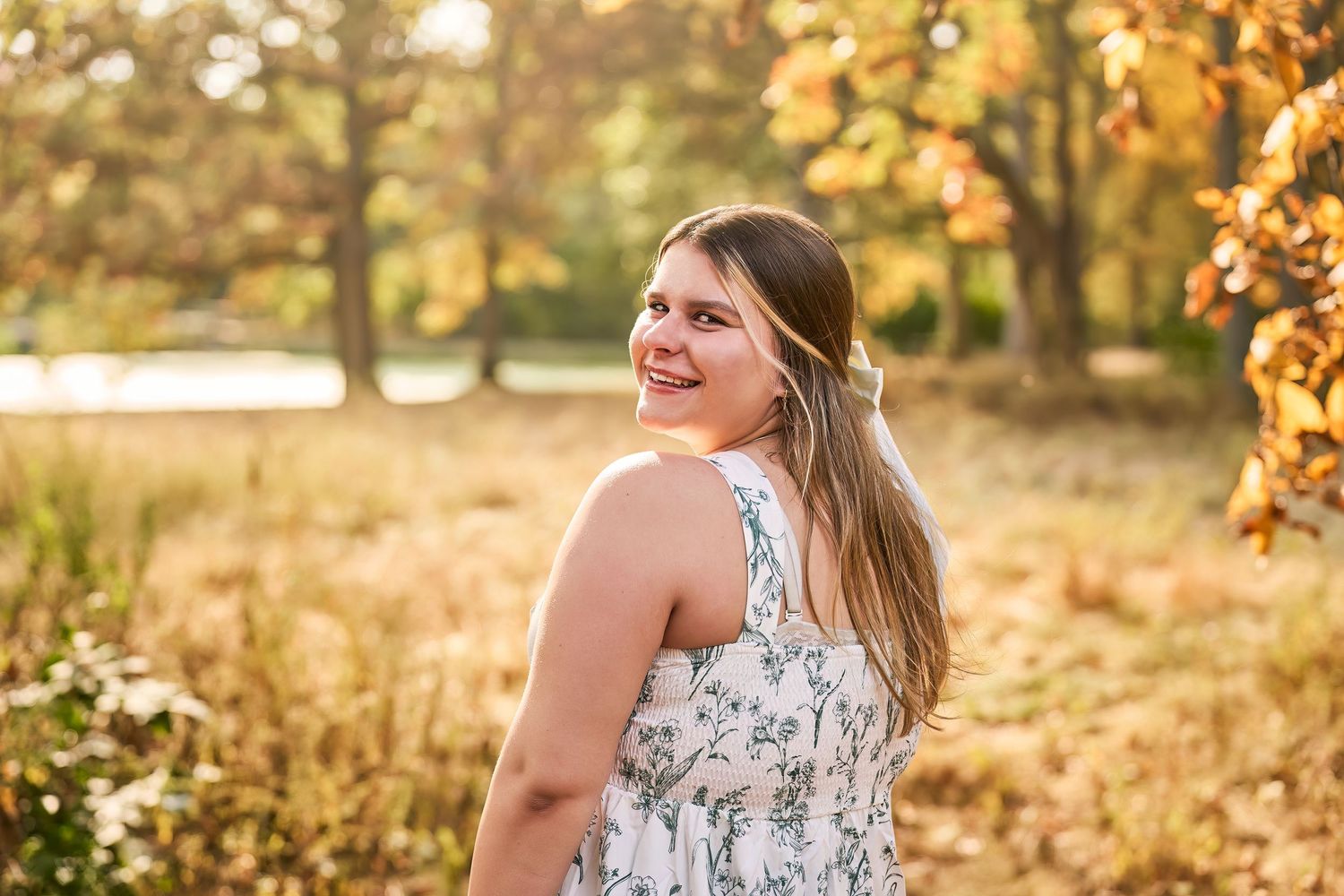 A golden autumn photoshoot in a sunlit park with warm lighting and fall foliage creating a magical atmosphere.