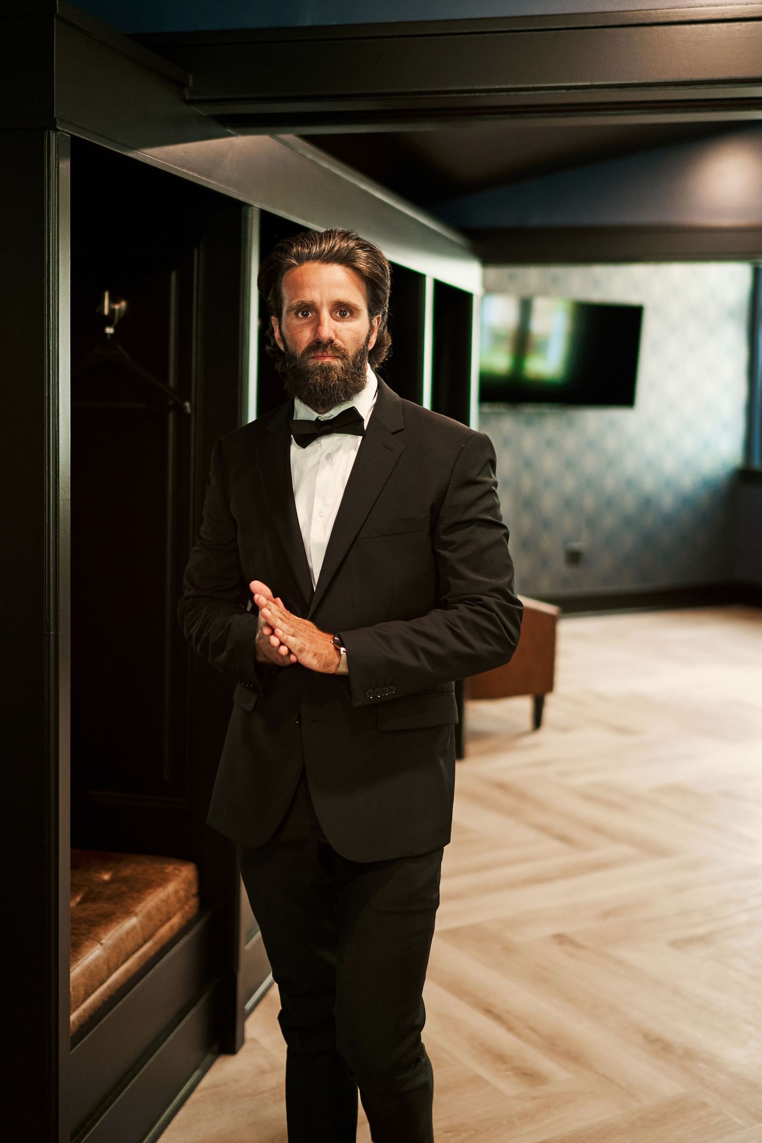 Formal black and white portraits in a stylish interior with herringbone flooring and modern decor.