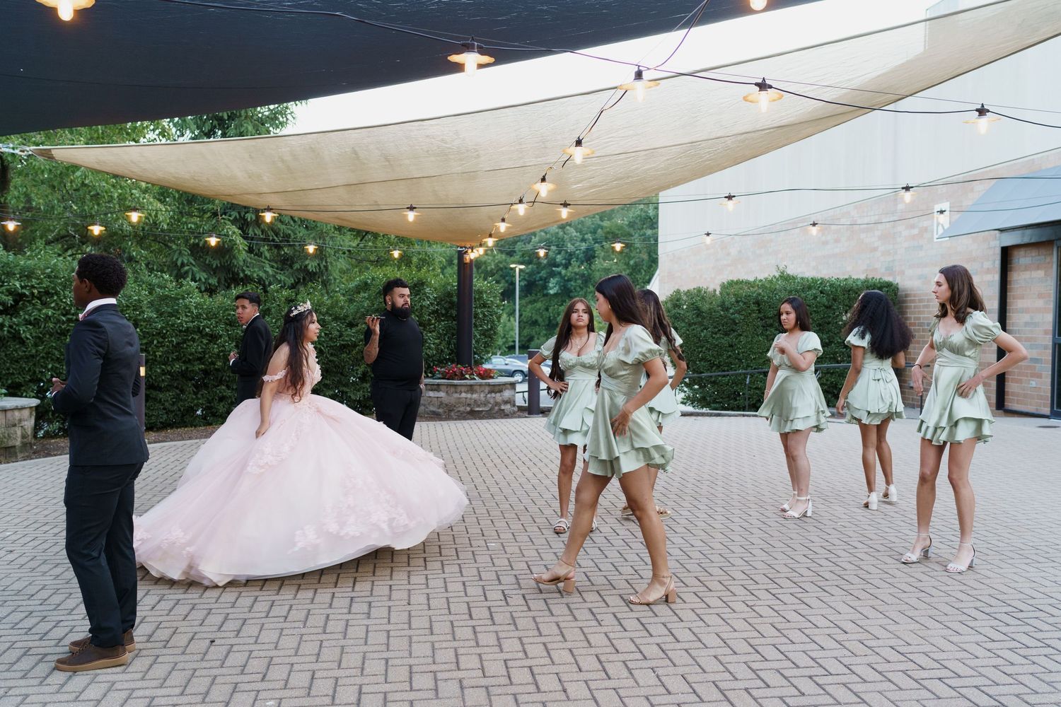 A quinceanera and her court practicing their dance in the courtyard of The Center of Visual and Performing Arts in Munster, IN