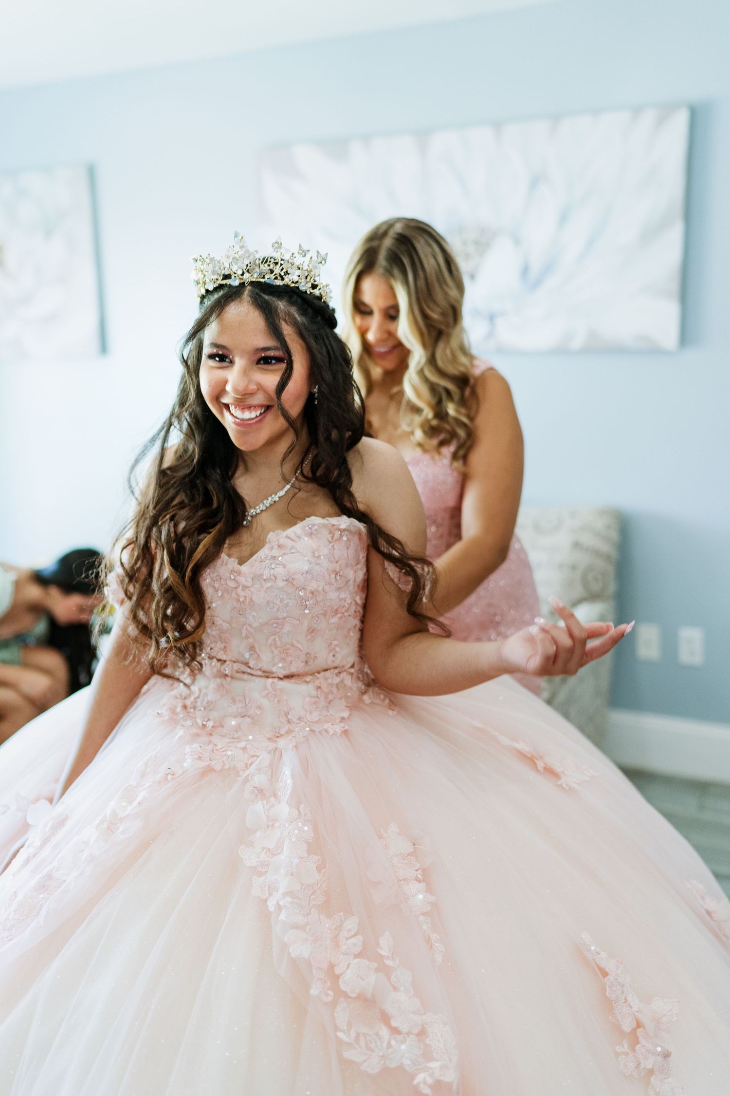 Beautiful quinceanera dress with intricate lace details and full tulle skirt in soft pink.