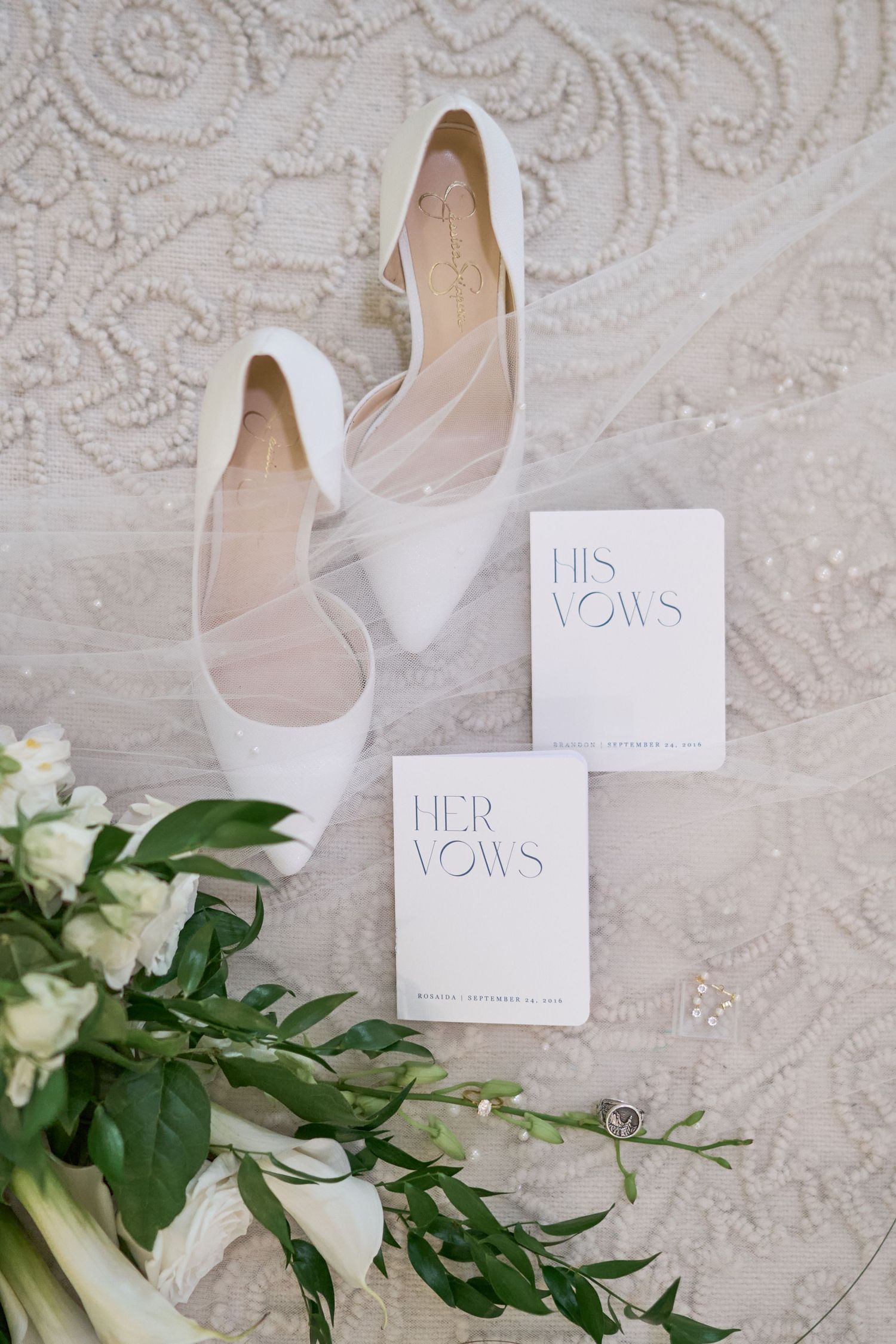 Detail flatlay of bride's shoes, veil, and bouquet; as well the bride and groom's rings and vow books | Indiana wedding photographer