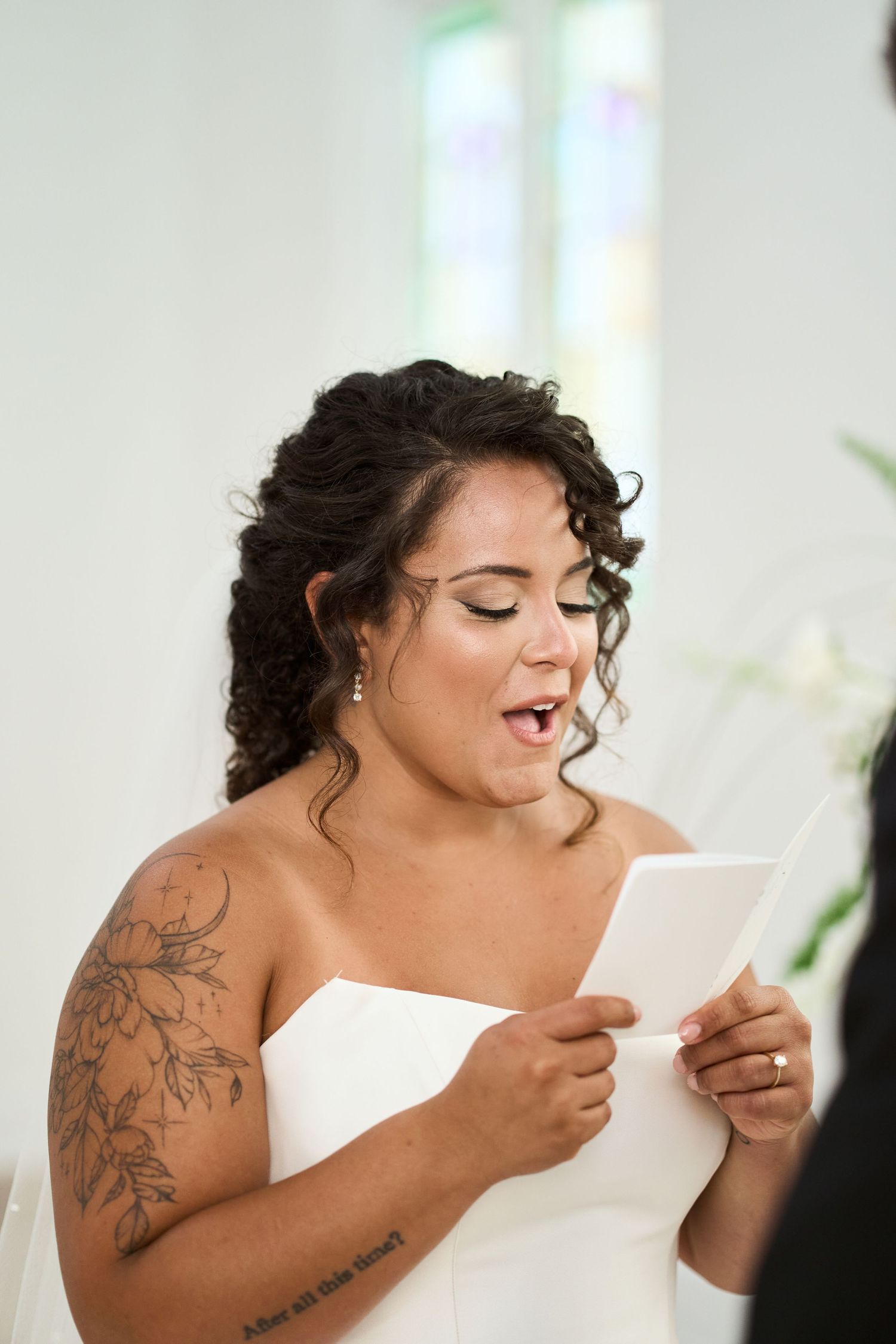 An emotional moment as a bride reads from a paper during the wedding ceremony.