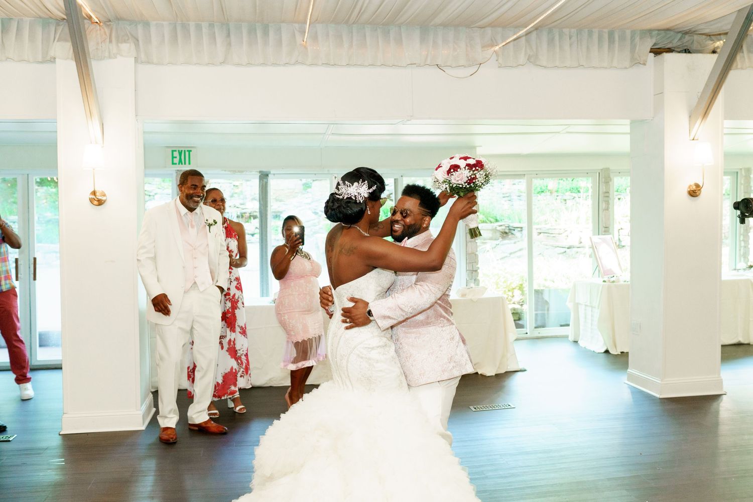 A romantic first dance moment at an elegant indoor wedding reception.