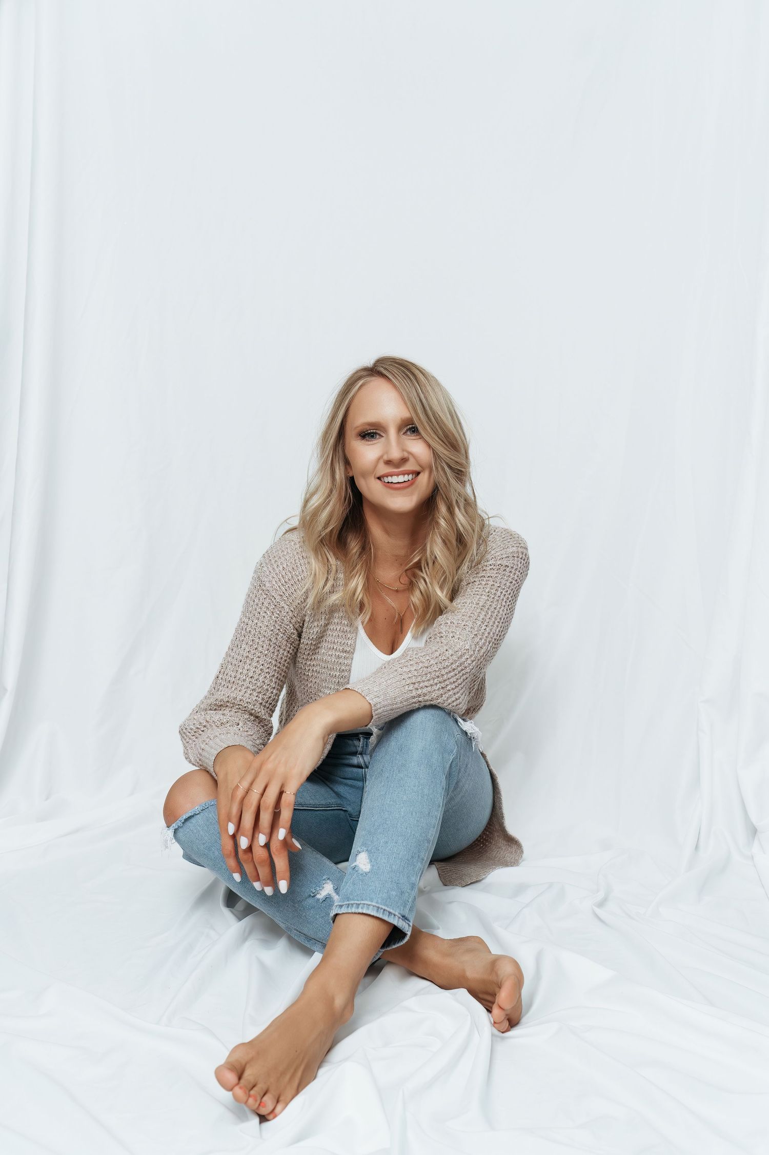 Casual lifestyle photography series showing someone in jeans and sweater poses against white backdrop.