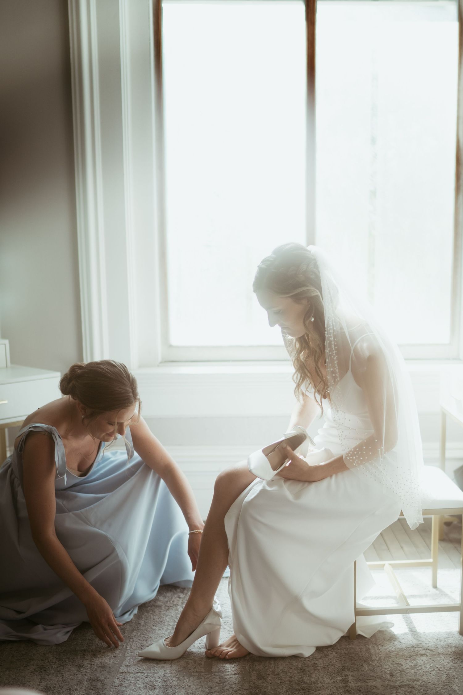 Two people sit on the floor near a bright window in a soft, dreamy sequence of intimate moments.