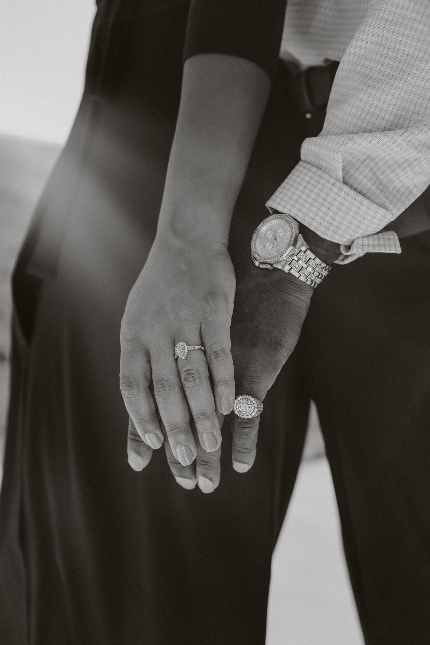 Black and white close-up photos of hands wearing wedding rings in a series of romantic detail shots.