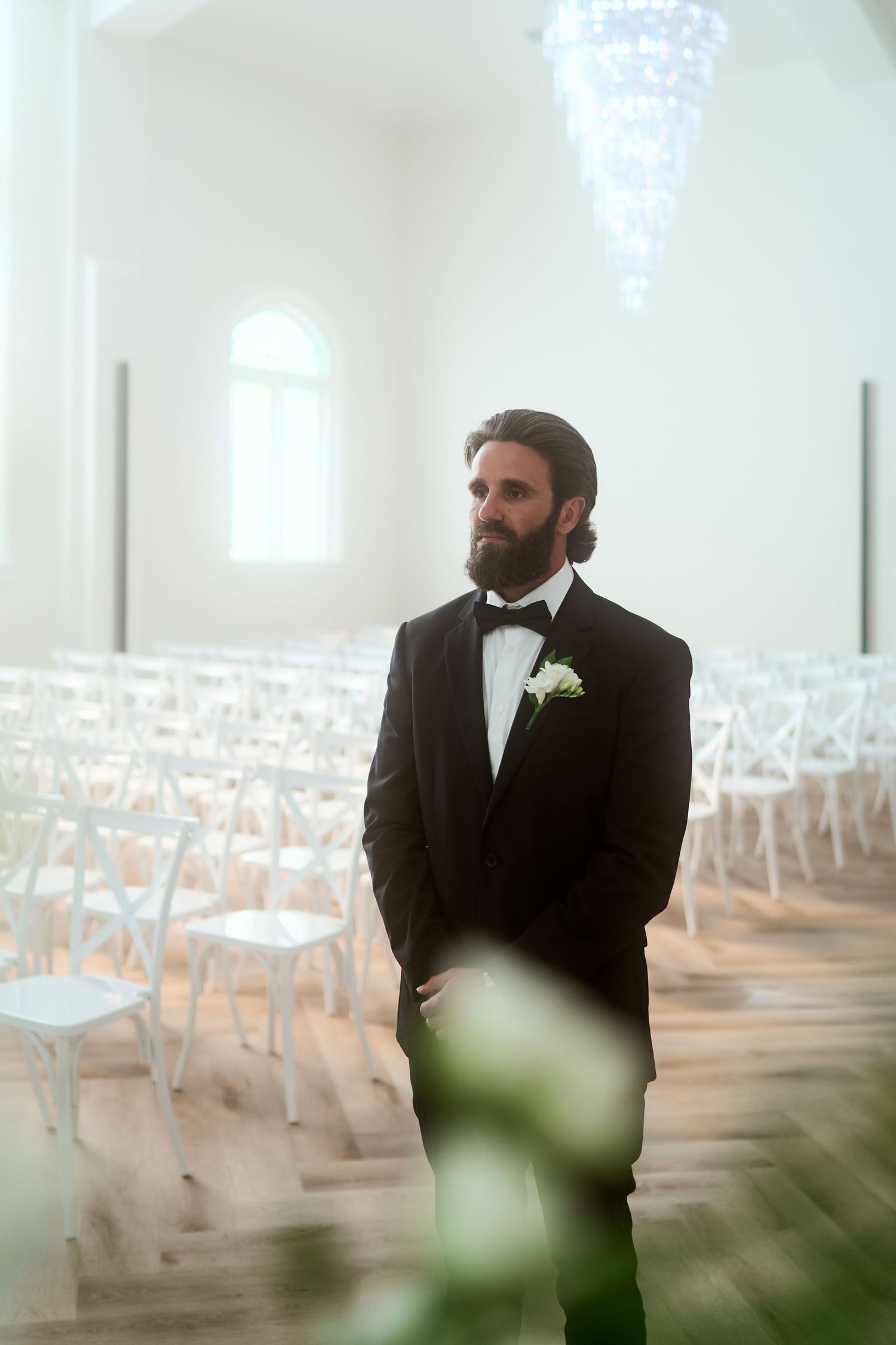Light-filled church interior with white chairs and ethereal atmosphere.