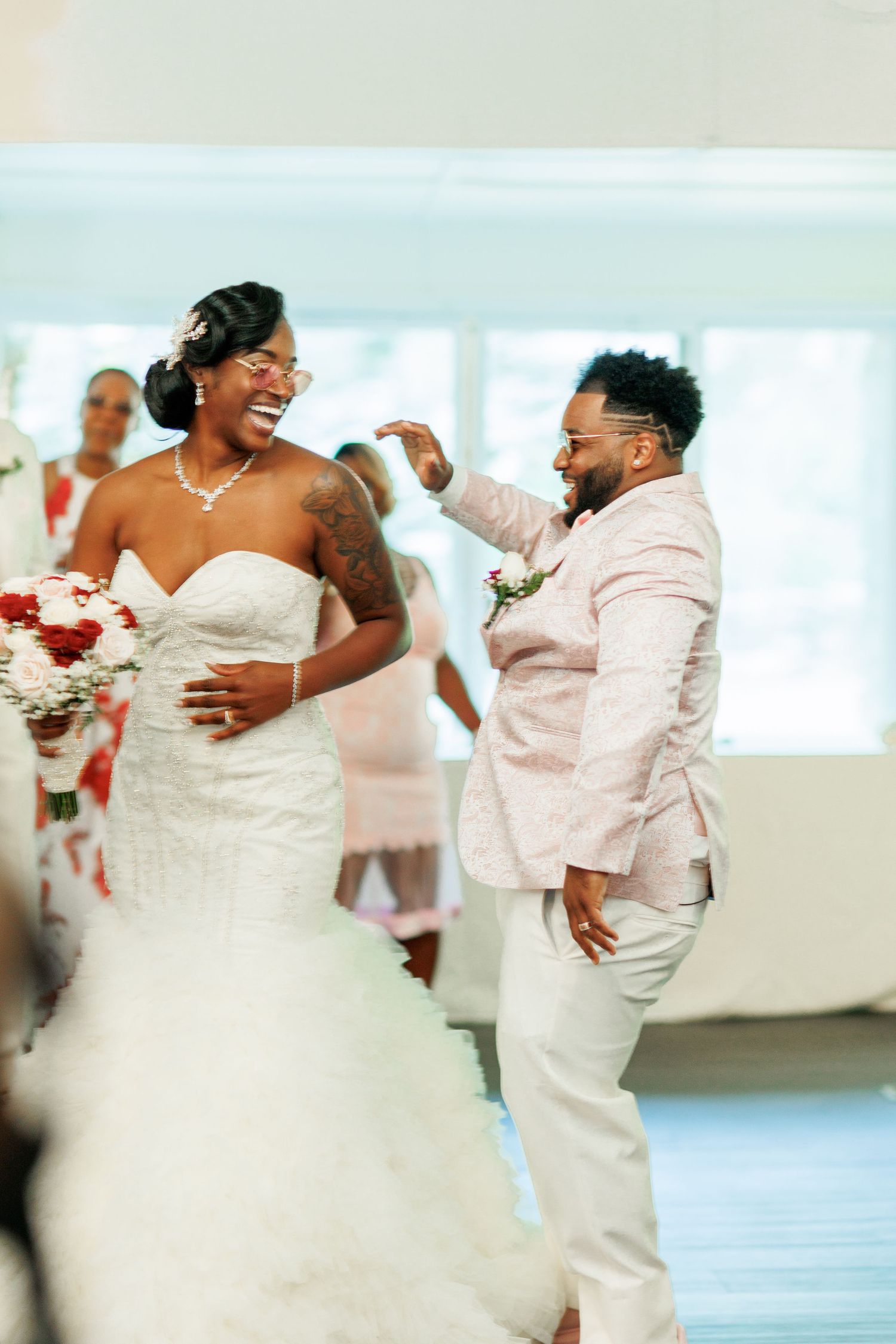 A candid moment of joy and laughter during the wedding reception festivities.