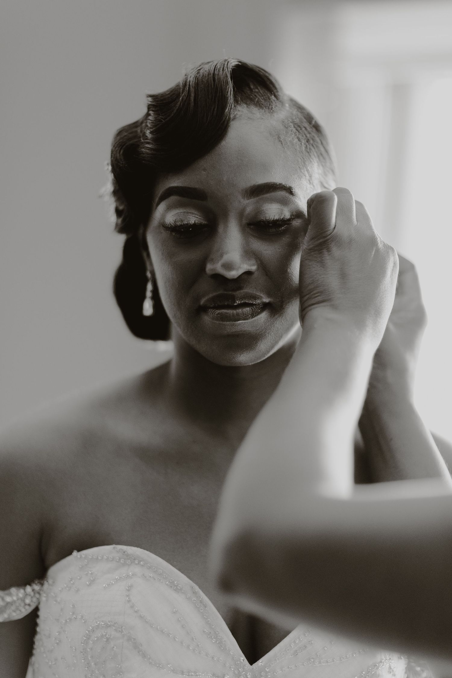 Intimate black and white bridal portrait capturing an emotional pre-wedding moment.