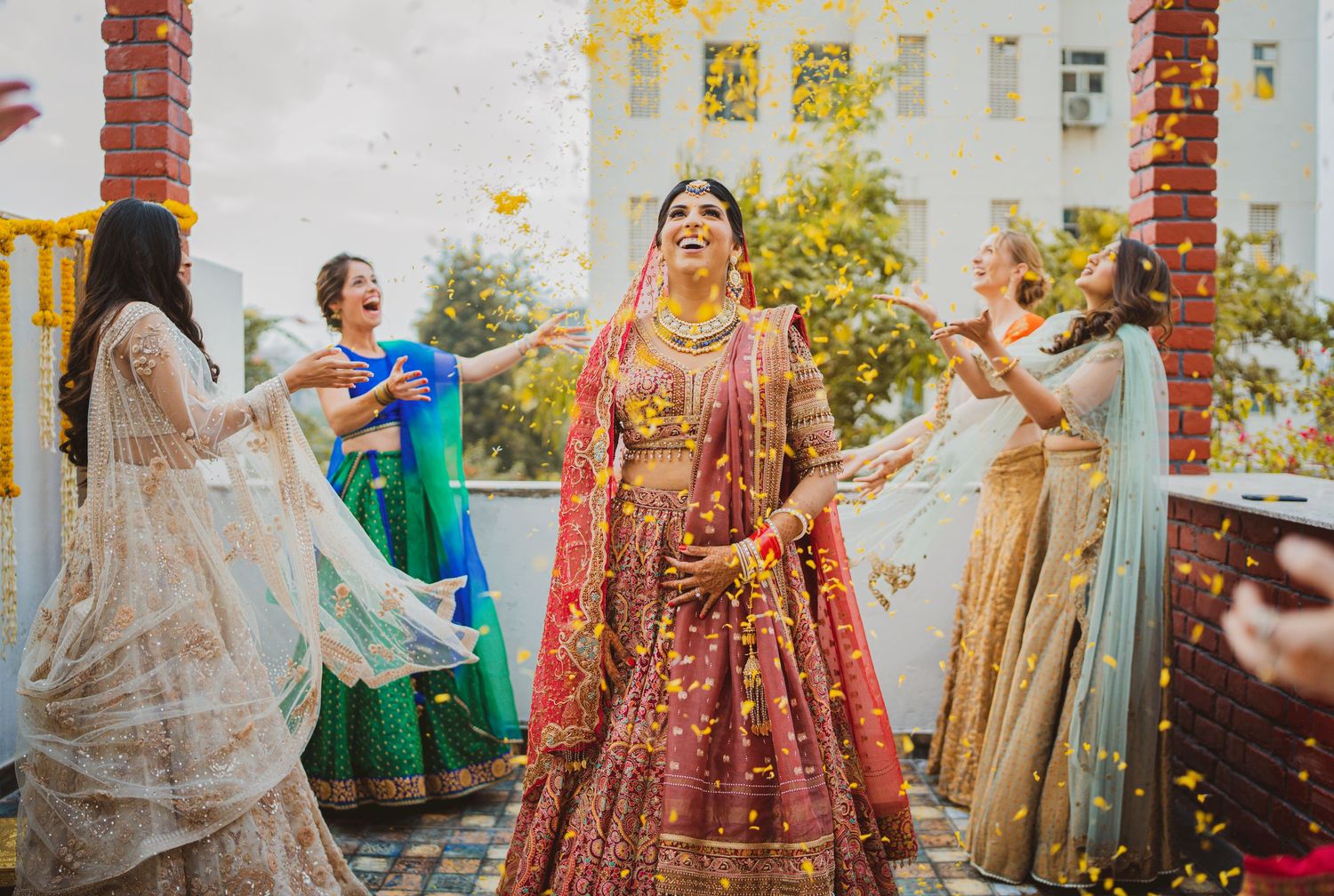 A sequence of Indian wedding celebration photos showing traditional bridal outfits and joyful dancing moments.