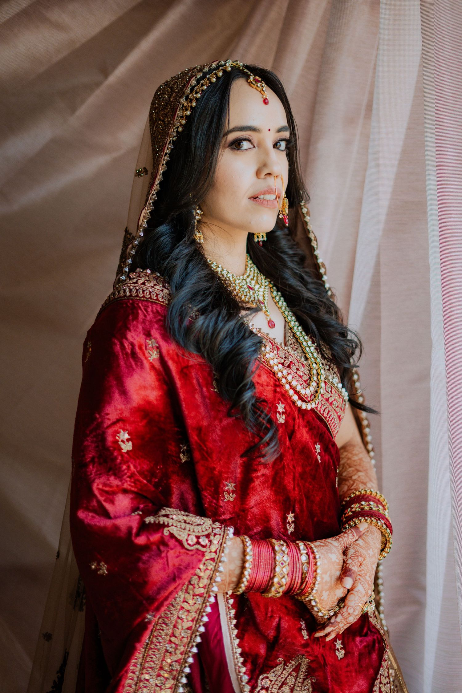 Sequence of shots showing bride in stunning red traditional Indian bridal attire with gold details.