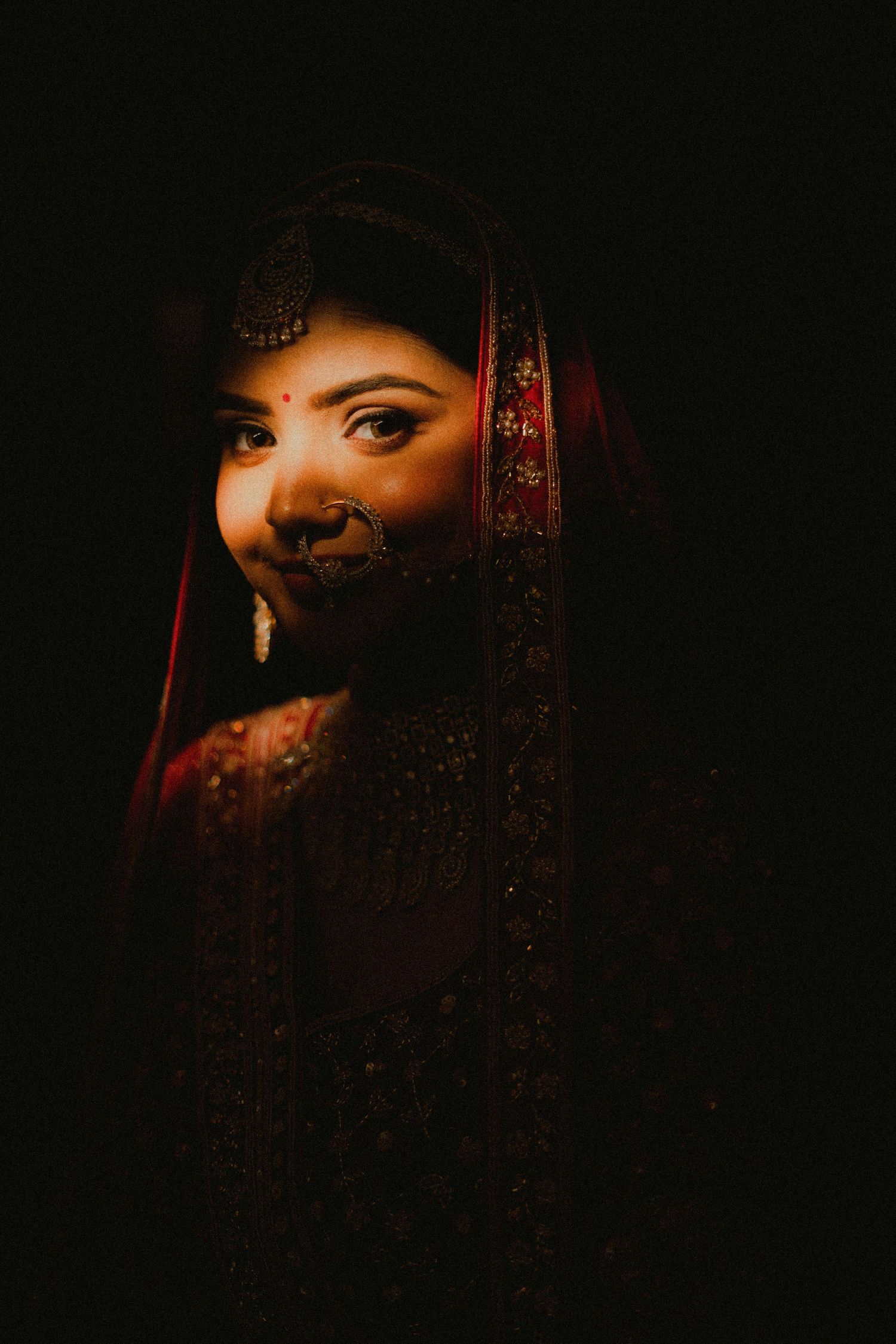 Artistic close-up portrait series with dramatic lighting and red tones creating a mysterious atmosphere.