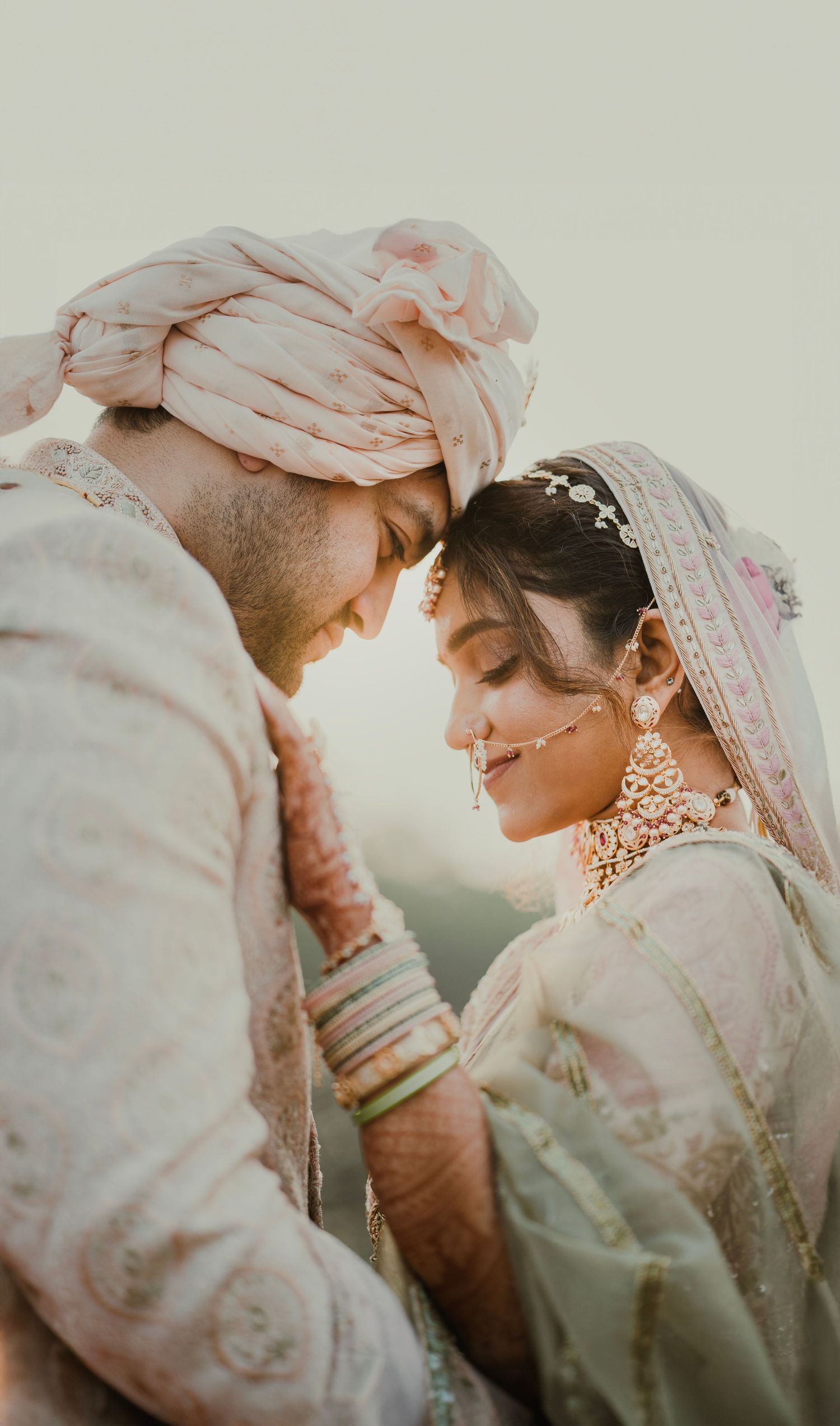 Intimate wedding portraits showing tender moments between couple in traditional Indian attire.