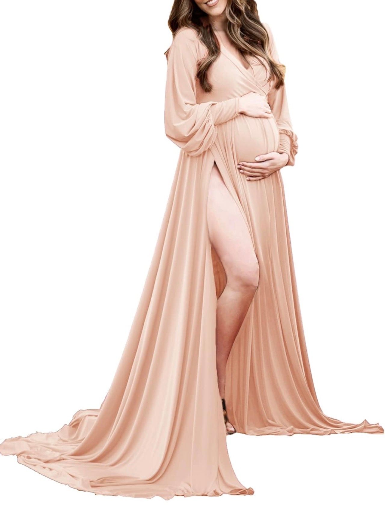 Pregnant woman wearing a flowing blush pink maternity gown with long sleeves, deep V-neck, and elegant front slit train.