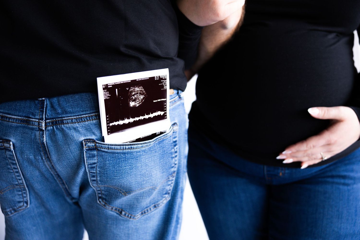 Series of cropped photos showing a pregnant belly in blue jeans and black top from different angles.