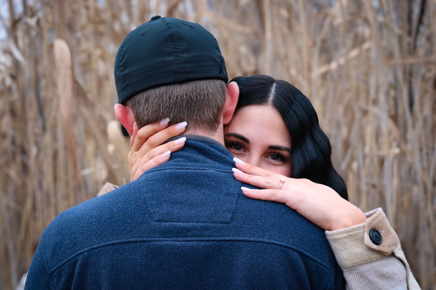 Intimate outdoor couple portraits among bare winter trees.