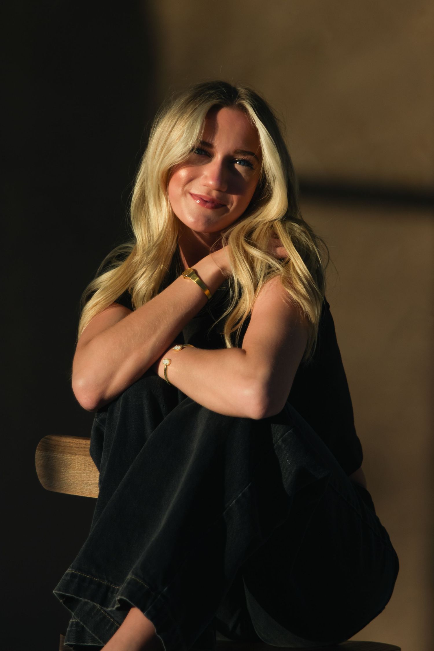 Portrait of a young woman sitting down at First North Studio in Bixby, Oklahoma, at golden hour