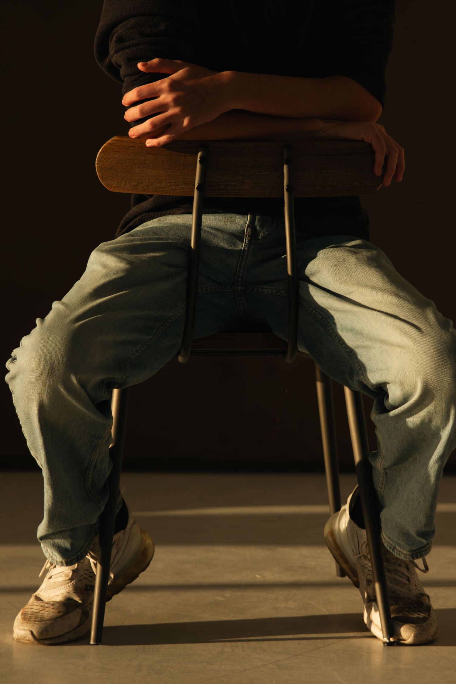 Up close photo of a young man sitting down at First North Studio in Bixby, Oklahoma, at golden hour