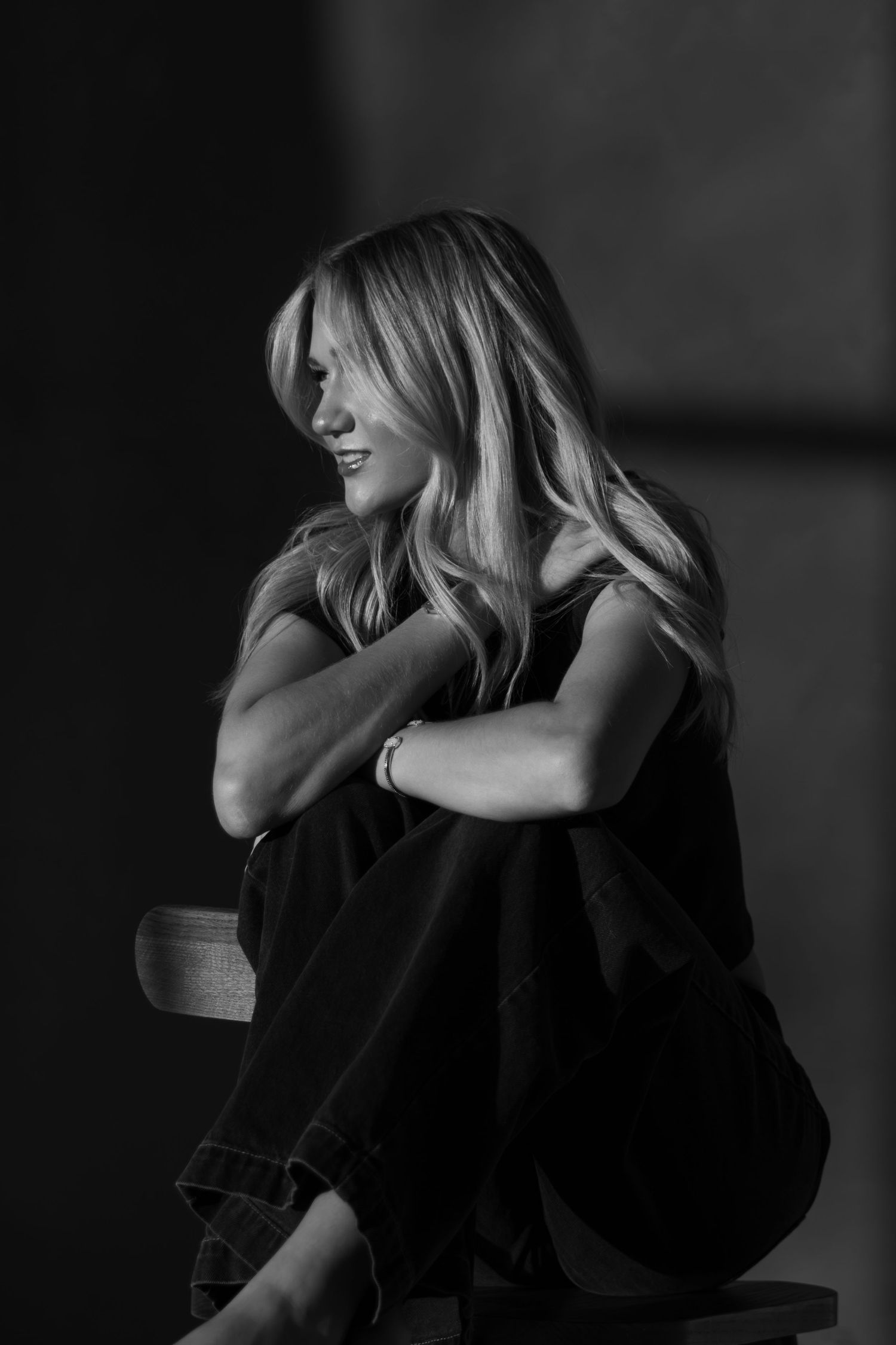 Black and white portrait of a young woman sitting down at First North Studio in Bixby, Oklahoma