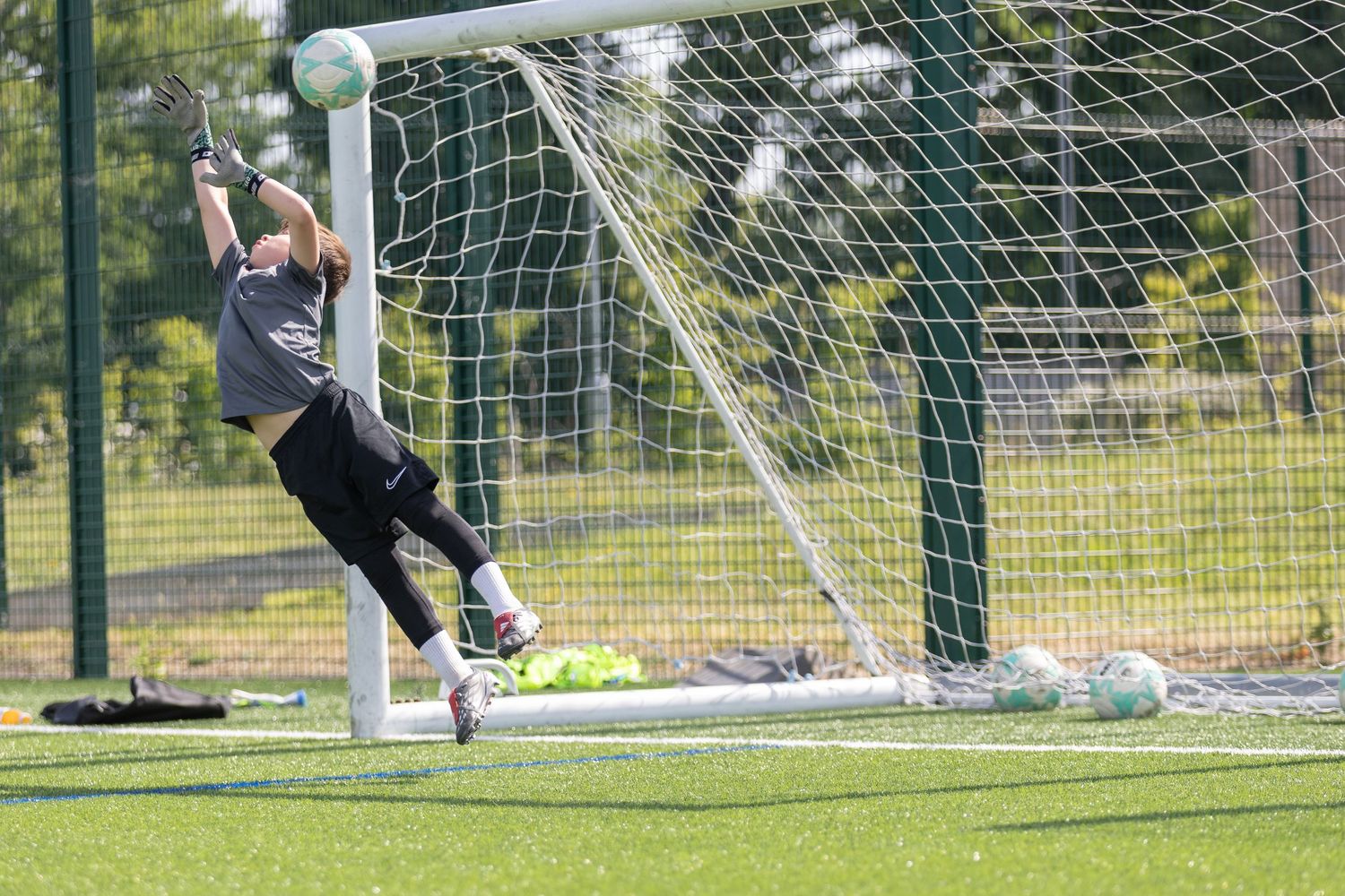 goalkeeper full stretch to save a ball