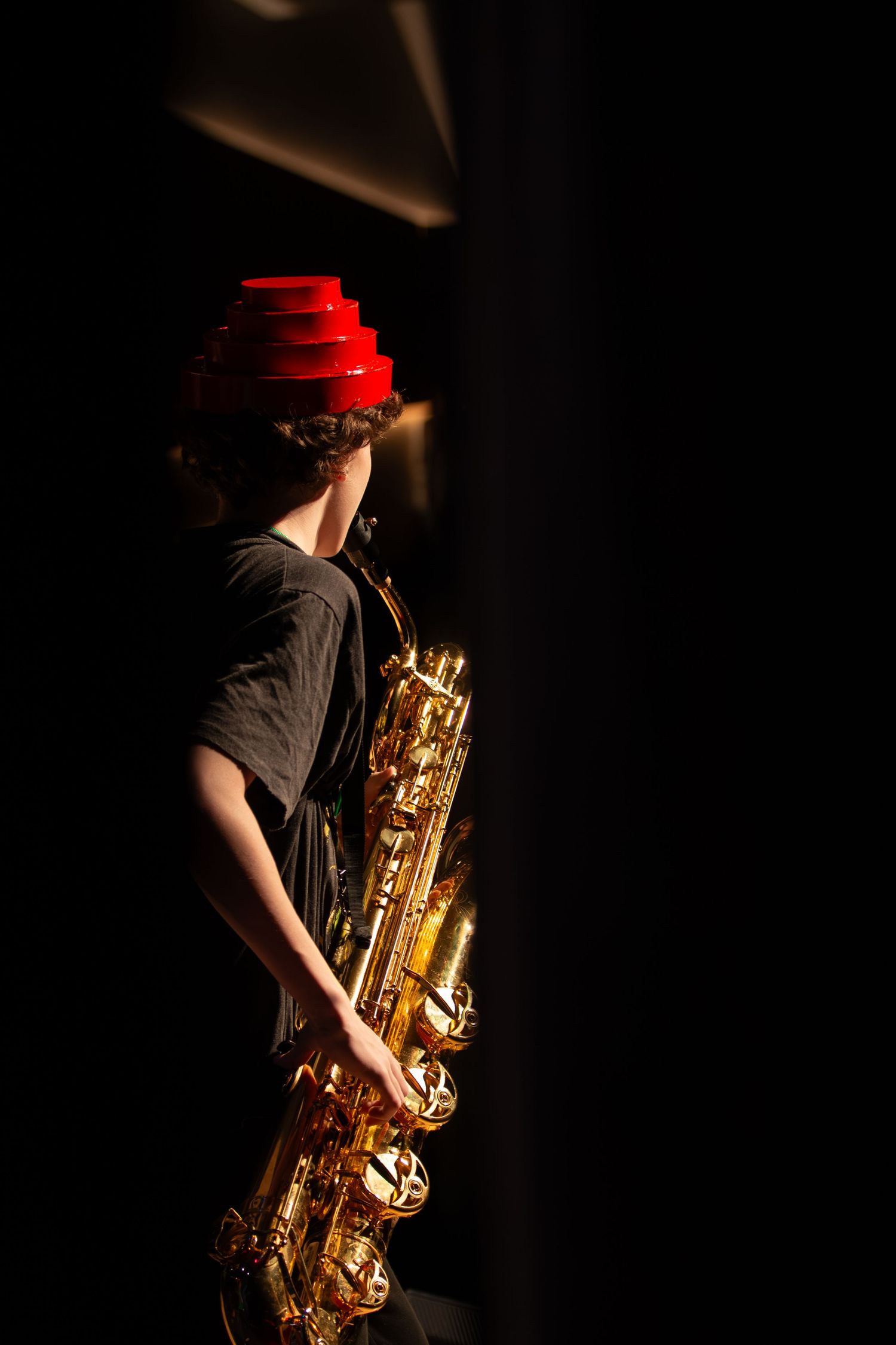 A person playing the saxophone into a microphone.
