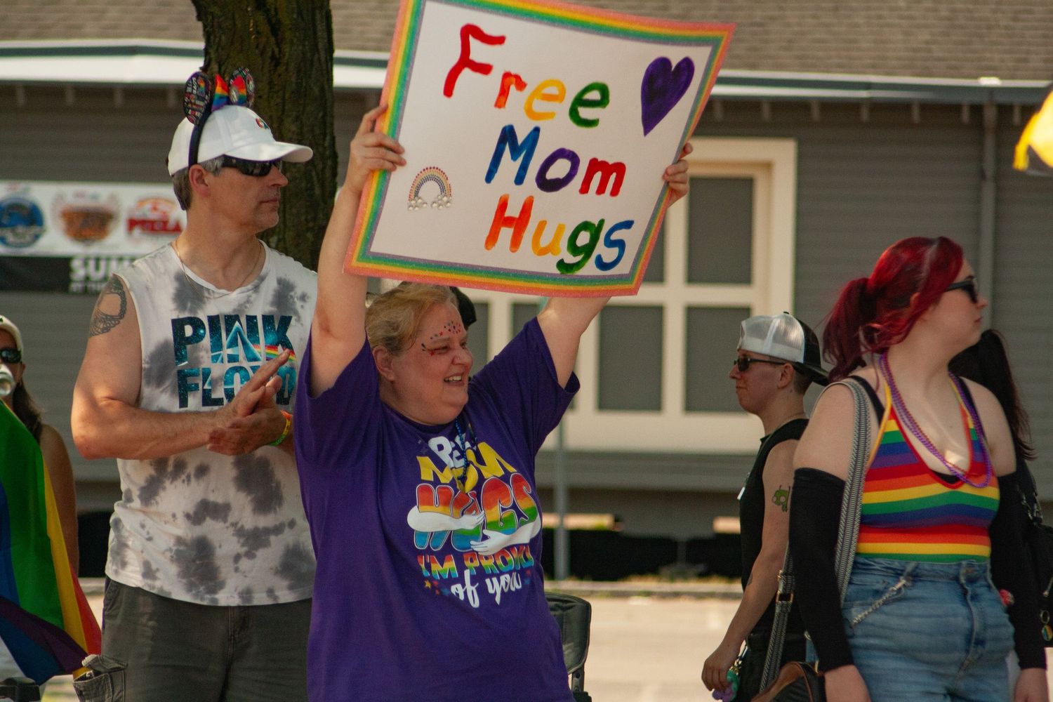 A grandma or old lady holding a sign up high that says 