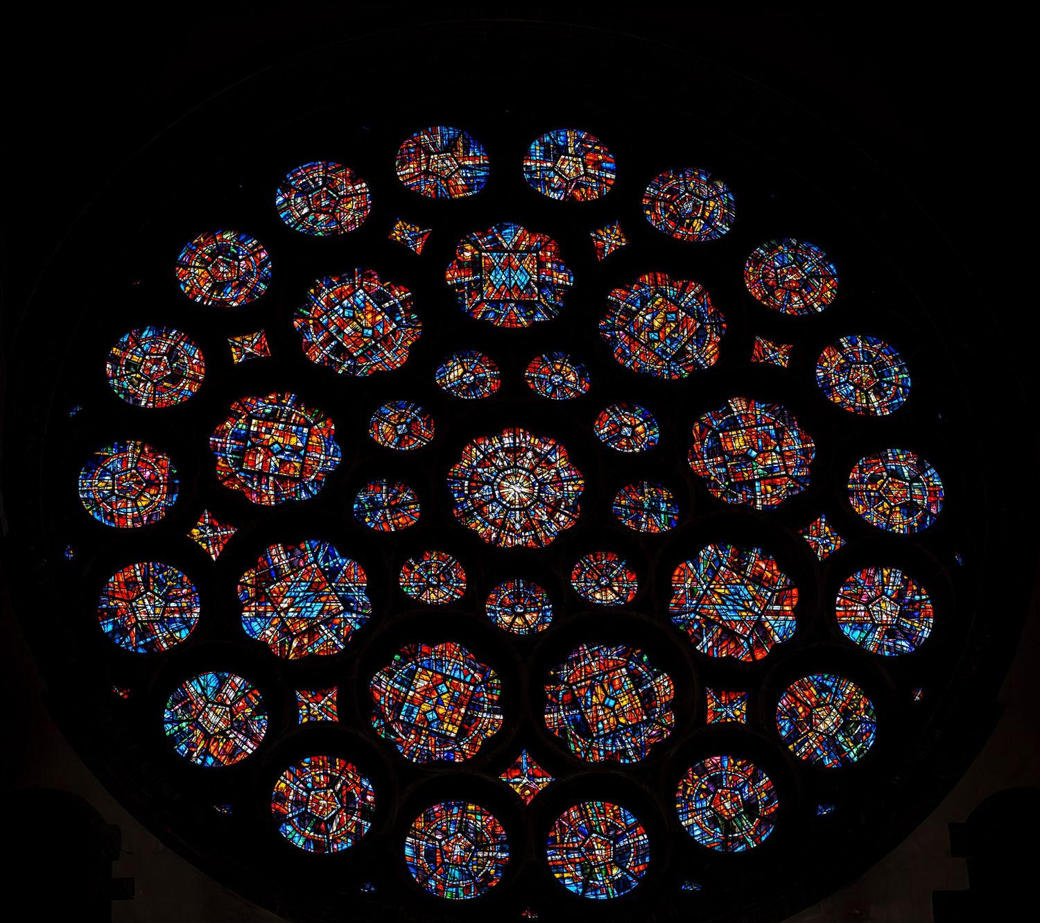 Stunning circular rose window with colorful stained glass in a cathedral. Photo Taken by AJCoatesPhotography