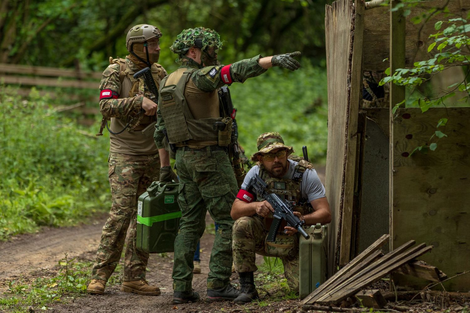 Military soldiers in camouflage gear strategizing during outdoor woodland tactical training operation. Photo Taken by AJCoatesPhotography
