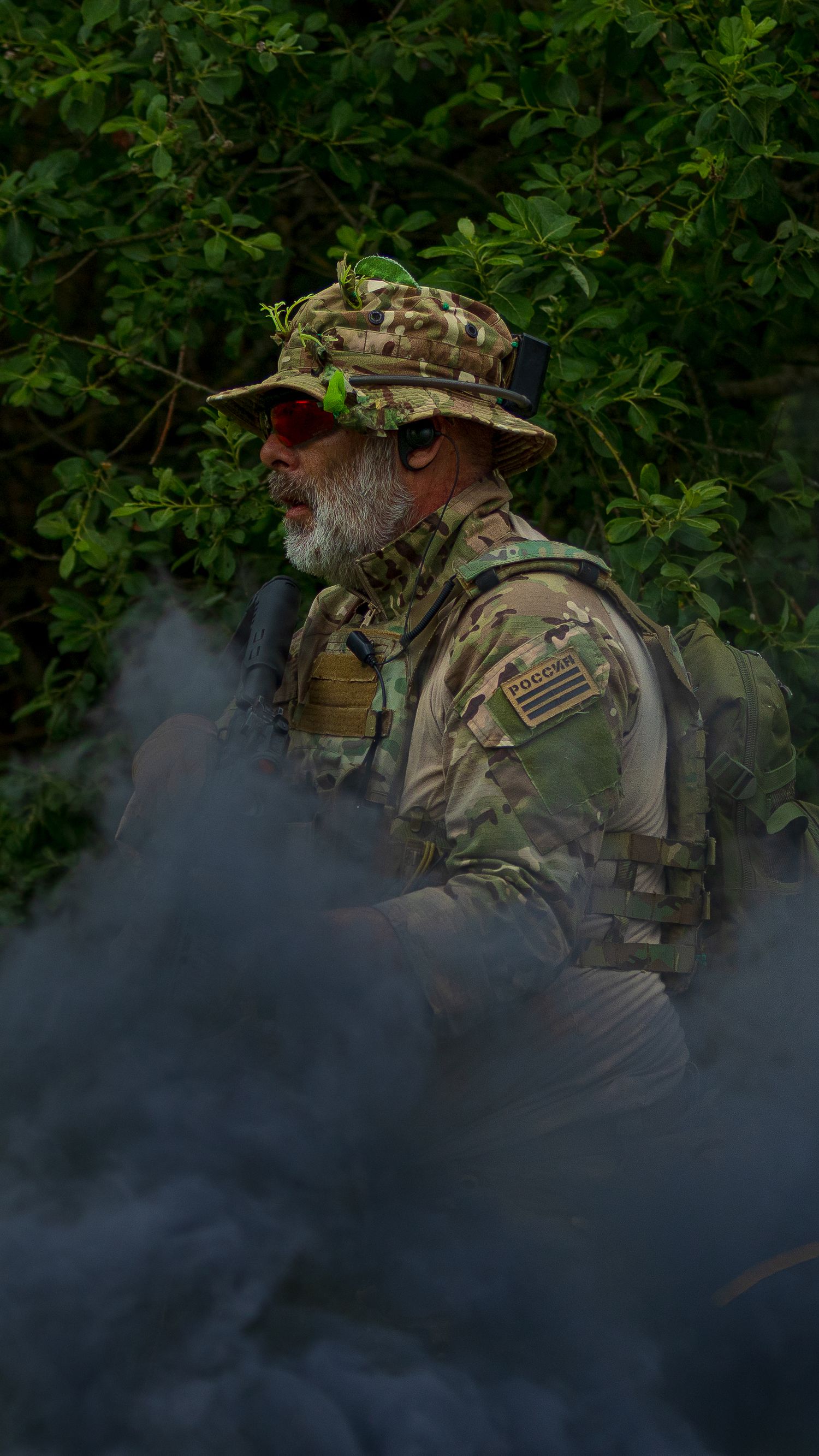 Bearded soldier in multicam boonie hat and tactical vest standing in smoke during outdoor military exercise. Photo Taken by AJCoatesPhotogra