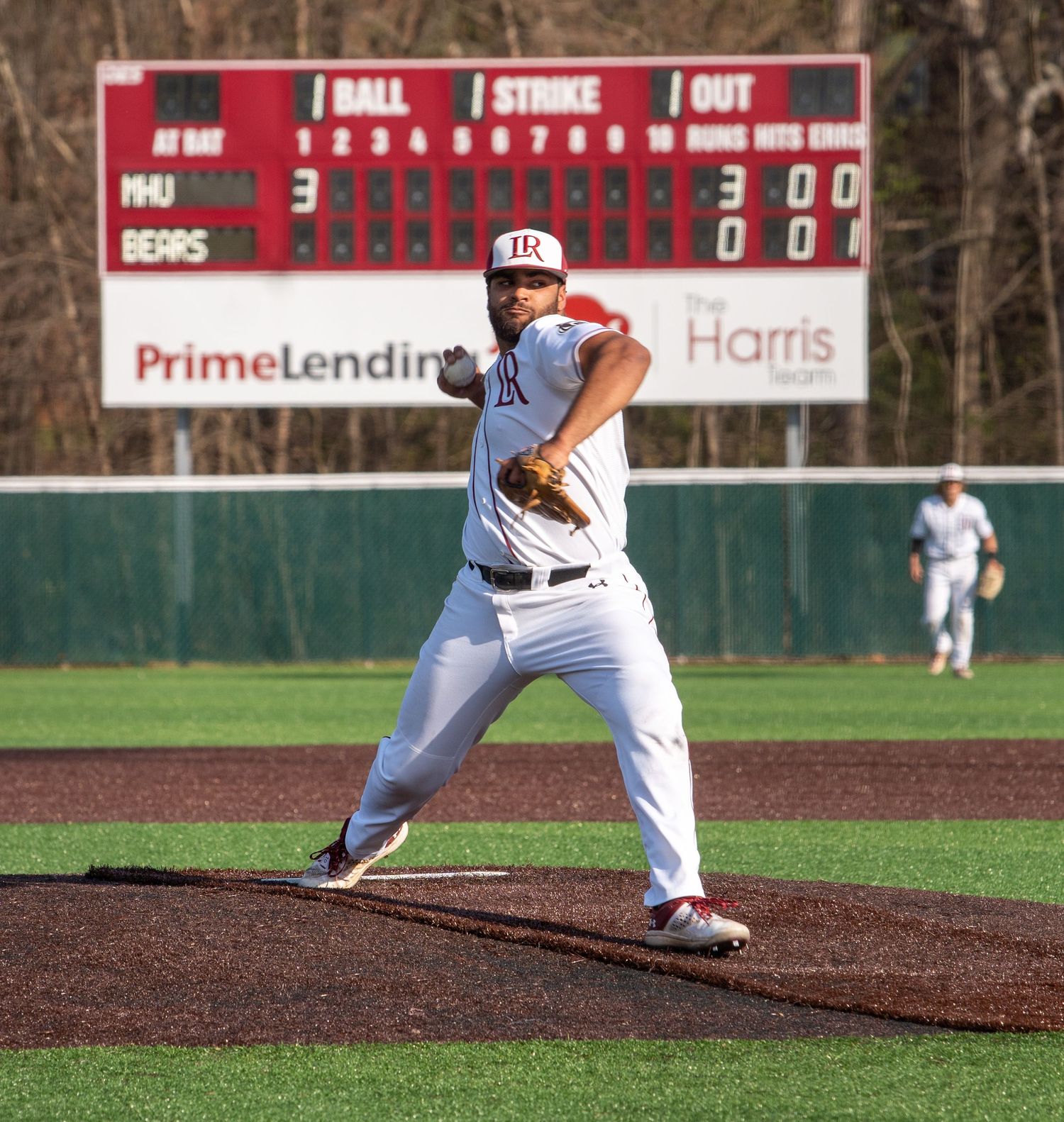 Baseball pitcher throws from the mound during a game.