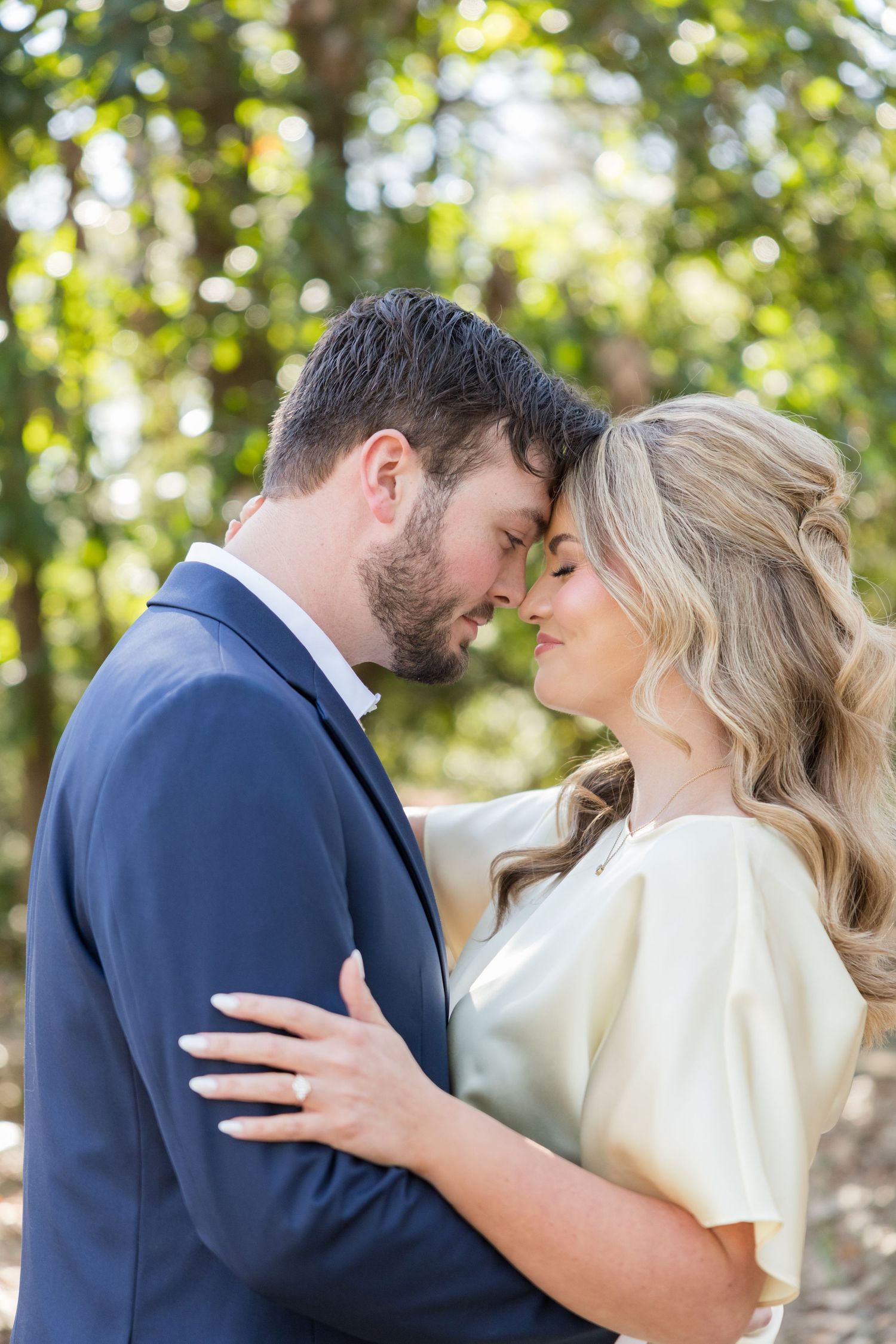 Bride and groom sharing a romantic moment during an outdoor Alabama wedding.