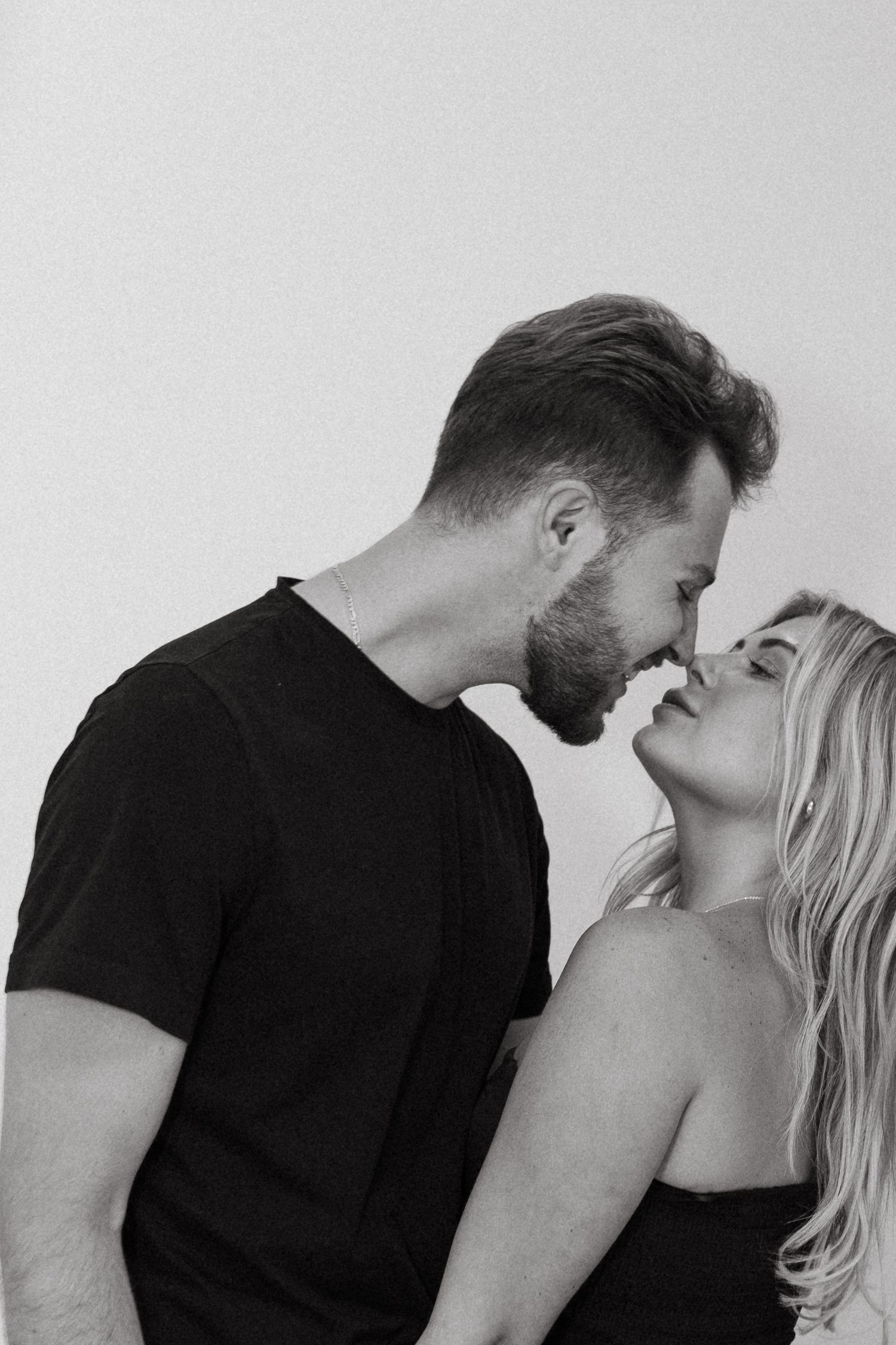 Black and white romantic couple almost kissing in an intimate close portrait.