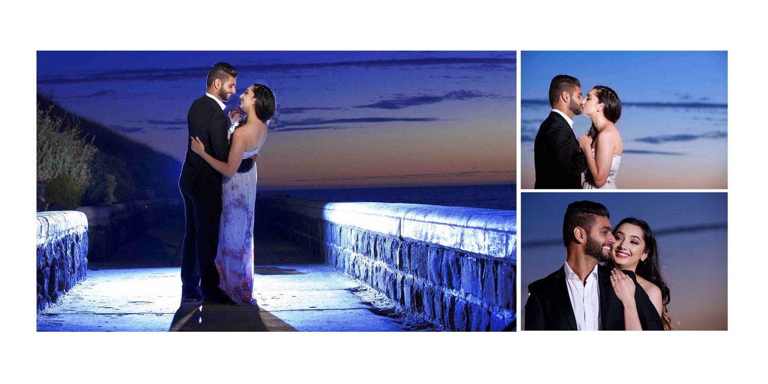 Romantic couple embracing at sunset on a stone bridge with stunning blue twilight sky backdrop.